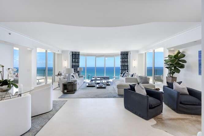 Experience the exquisite 14th floor 3-bedroom corner Savona model, offering panoramic ocean views from every impeccably appointed room. Recently reimagined by Clive Daniels Homes, it draws inspiration from Florida's breathtaking shoreline. Inside, a sophisticated modern beach retreat unfolds with pristine white sandstone marble floors throughout. The ocean-facing great room exudes elegance, featuring a state-of-the-art electric fireplace and bespoke TV monitor. Lavish custom draperies adorn the kitchen, great room, and primary bedroom. Recent upgrades include luxurious vanities, LED high-hats, sconces, ceiling fixtures, a Sonos sound system, and a Lutron lighting control system via mobile app. Luxury redefined, where every detail reflects coastal living at its finest. Turnkey