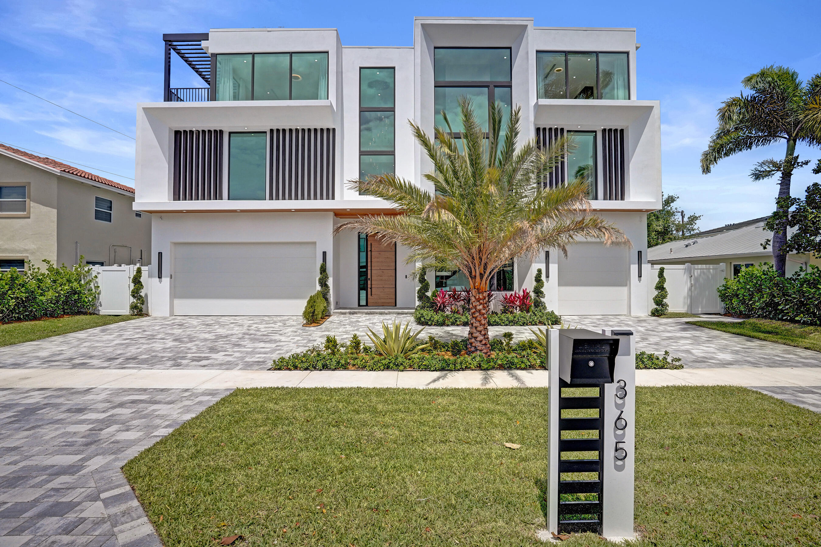 Welcome to Villa Aurelia, the Golden Villa, a recently completed modern masterpiece, located in the sought after Golden Triangle neighborhood of East Boca Raton, just moments from Mizner Park, the Intracoastal and the glistening waters of the Atlantic Ocean. Offering 7554 sqft  of elevated living, this residence features 5 bedrooms, 5 full baths, and 3 half baths, along with a private office, club room, loft, elevator, and two laundry rooms—perfectly balancing luxury and functionality. The chef's kitchen is truly inspirational with Italian imported custom cabinetry, Wolf and Sub-Zero appliances, Crystallo countertops, a full wine refrigerator, built-in espresso machine, and a separate butler/kosher kitchen—ideal for seamless entertaining. Impressive details such as one of a kind, Italian magnetic doors, stunning custom built closets, and countless lavished design elements are showcased throughout. The primary suite is a private retreat with a spa-like bath, two expansive walk-in closets and its own dedicated AC zone. Additional highlights include Control4 smart home technology, natural gas, tankless hot water heater, impact windows, and a convenient elevator connecting all 3 levels seamlessly. The home is generator-ready for ultimate peace of mind. The tranquil outdoor living space is exceptional, featuring a 38 foot saltwater pool with sun shelf, covered patio, and two fully equipped summer kitchens—one poolside with cabana bath and outdoor shower, and a second one on the stunning rooftop terrace showcasing panoramic views of downtown Boca Raton, perfect for sunset entertaining.  Offered furnished with designer Italian pieces. Electric shades and curtains included. Villa Aurelia is a rare opportunity to move into a brand-new, thoughtfully curated ultra-luxury home that is truly one of a kind.