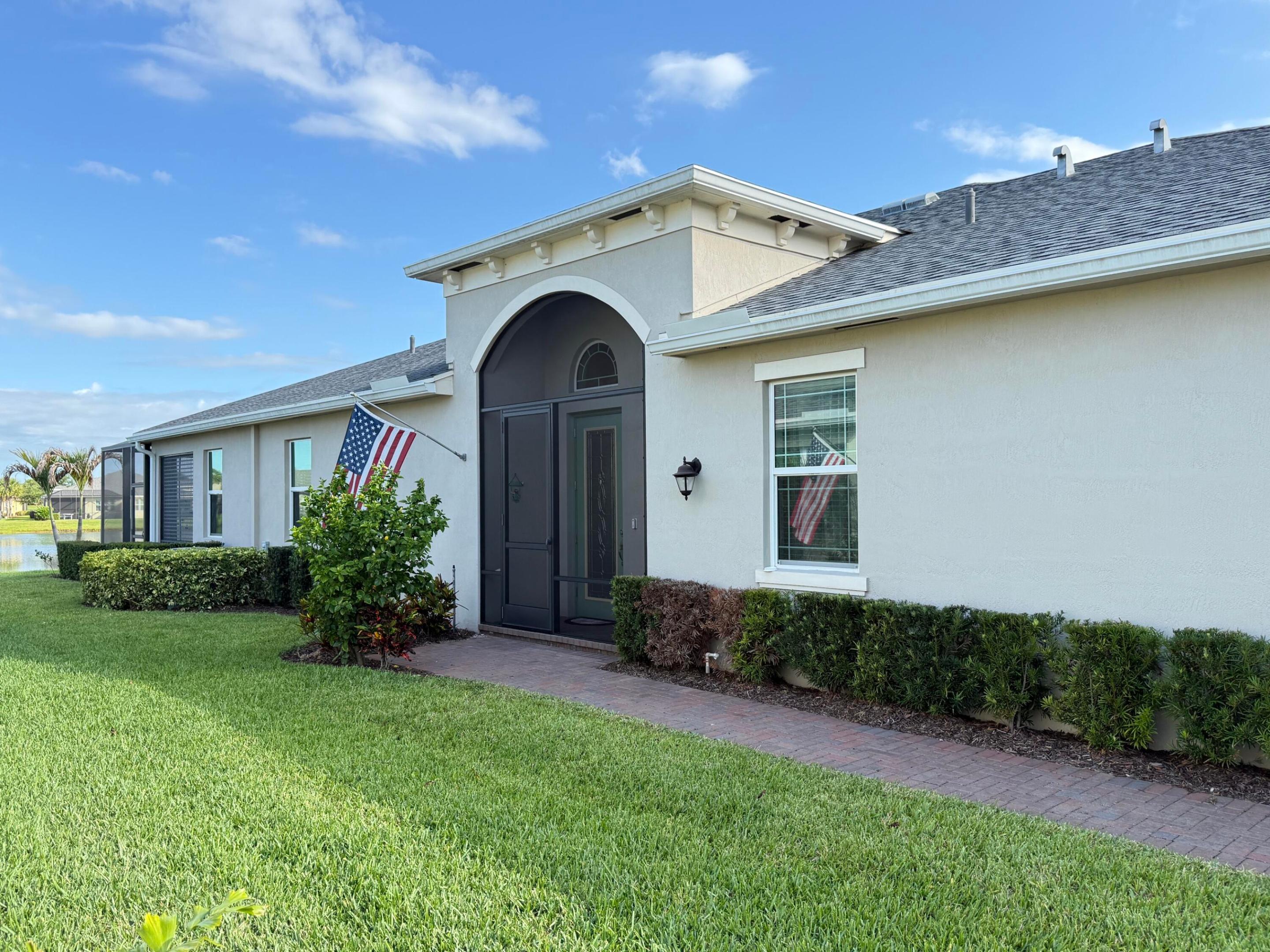 Welcome to the wonderful world of LakePark at Tradition, where an Active Adult Community awaits your relaxation and tranquility.  A beautiful 2 bedroom villa with 2 inviting bathrooms and den/office or 3rd bedroom with an open spacious living room and kitchen and dining room.  A beautiful screened lanai over looking the Lake with plenty of room for outdoor living and relaxing watching beautiful sunsets.  New construction completed in 2020 and is great condition.   Recently exterior new paint and paver driveway and sidewalk.  Impact windows and doors for peaceful security and spacious 2 car garage.  Laundry room with all appliances included.    Open floor plan with beautiful wood cabinets and corian countertops and tile floors throughout.  This home is waiting for your arrival.