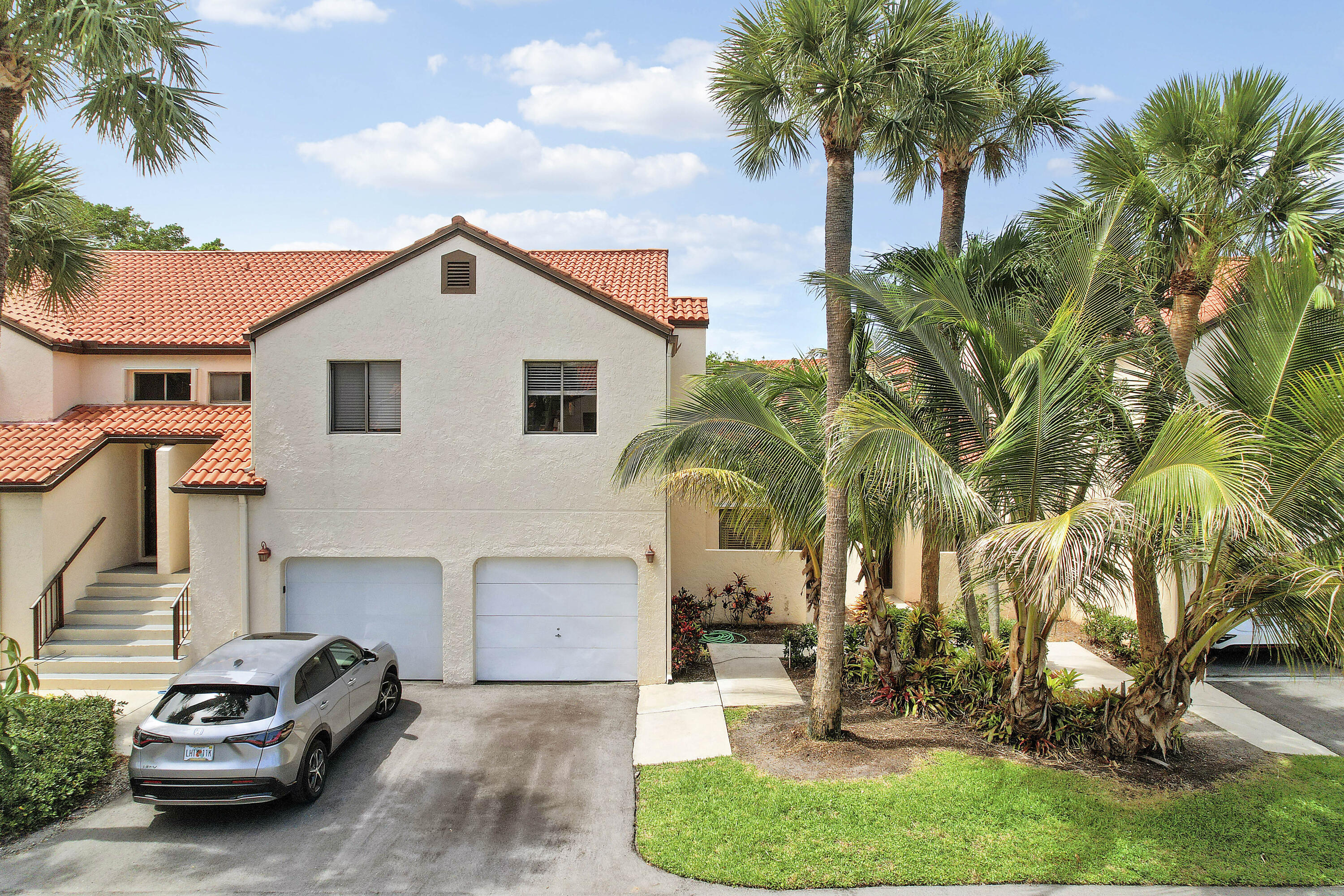Move right into this beautifully remodeled 2-bedroom, 2-bathroom first-floor condo in the gated community of Dos Lagos, ideally located in the heart of Boynton Beach. Every detail has been thoughtfully updated, featuring large-format wood-look tile flooring, fresh designer paint, and a stunning kitchen with quartzite countertops, stainless steel appliances, bar seating, and a stylish tile backsplash. The spacious primary suite offers a luxurious bath with a double vanity, heated and lighted mirrors, an oversized walk-in shower with premium Delta fixtures, and a frameless glass enclosure. Additional highlights include a one-car garage with newer washer and dryer, fiber-optic internet, Reme Halo air purification system,  antimicrobial ductwork, LED lighting, upgraded electrical fixtures, tropicallandscaping, and access to the community pool and tennis courts. This meticulously maintained home combines modern comfort with exceptional quality in one of Boynton Beach's most desirable gated communities.