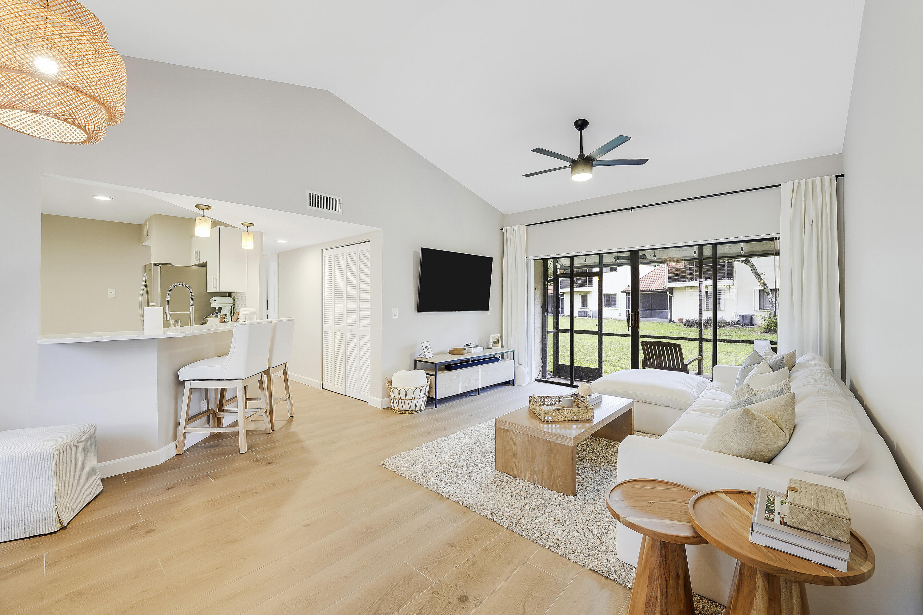 Move right into this beautifully remodeled 2-bedroom, 2-bathroom first-floor condo in the gated community of Dos Lagos, ideally located in the heart of Boynton Beach. Every detail has been thoughtfully updated, featuring large-format wood-look tile flooring, fresh designer paint, and a stunning kitchen with quartzite countertops, stainless steel appliances, bar seating, and a stylish tile backsplash. The spacious primary suite offers a luxurious bath with a double vanity, heated and lighted mirrors, an oversized walk-in shower with premium Delta fixtures, and a frameless glass enclosure. Additional highlights include a one-car garage with newer washer and dryer, fiber-optic internet, Reme Halo air purification system,  antimicrobial ductwork, LED lighting, upgraded electrical fixtures, tropicallandscaping, and access to the community pool and tennis courts. This meticulously maintained home combines modern comfort with exceptional quality in one of Boynton Beach's most desirable gated communities.
