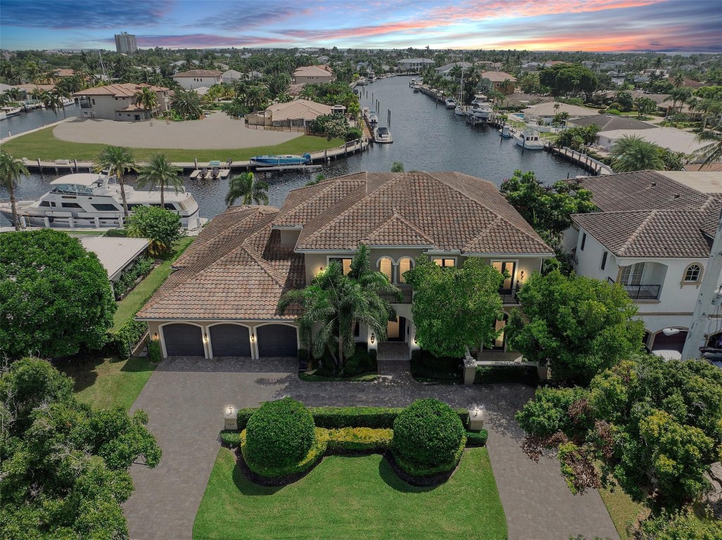 Discover this must-see waterfront masterpiece in the prestigious enclave of Lighthouse Point. Boasting 100' of pristine waterfront with travertine decking. This custom-built 6-bedroom estate invites you to enjoy serene water views & spectacular sunrises from the covered lanai, cabana & outdoor kitchen. Boaters will love the 2 boat lifts & large turning basin for your yacht, offering direct access to the Hillsboro Inlet. Crafted with steel-reinforced concrete block, the home includes a wired elevator shaft, a temperature-controlled wine room, and two laundry rooms. Each ensuite bedroom offers a private balcony, creating a personal retreat. Offered fully furnished (artwork excluded), this home is ready to welcome its new owner to a life of luxury. Lighthouse Point, Florida, is a quiet, waterfront community in Broward County known for its boating scene, stunning waterfront properties, and a close-knit, friendly atmosphere. Originally built on canals in the 1950s and 60s, it offers an ideal location for boating and fishing enthusiasts. With mild temperatures year-round and 230 sunny days annually, residents enjoy an active lifestyle with access to 20 acres of parks, marinas, and various outdoor activities like boating, fishing, golf, and tennis. The town also boasts excellent security, a new community center, and the historic Cap’s Place restaurant.