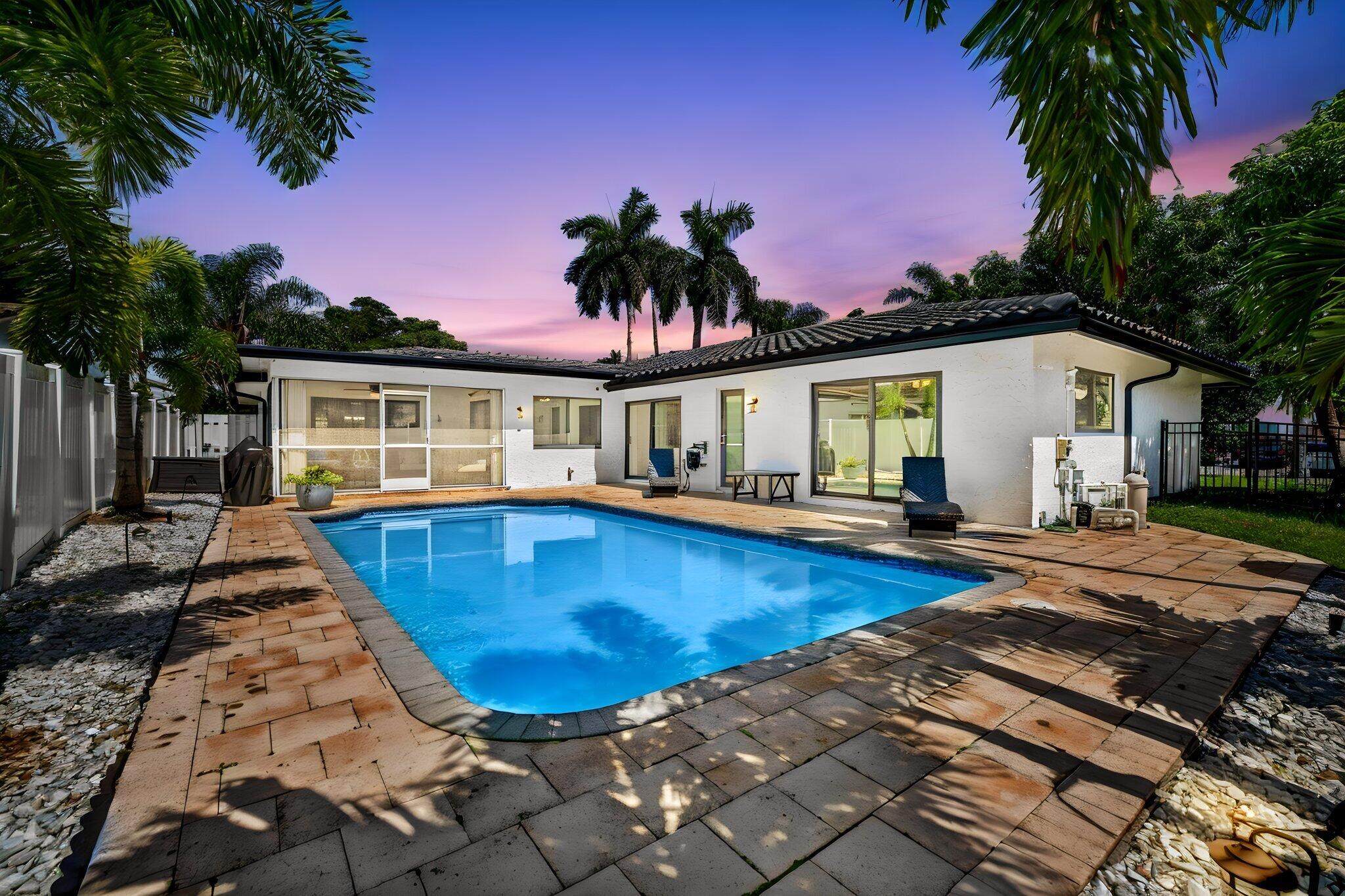 MOVE-IN READY! Rare waterfront retreat on a quiet cul-de-sac in the coveted Landings neighborhood! This 3BD/2.5BA CBS home boasts 100' of deep-water canal frontage with ocean access & a newer Trex dock — ready for your boat. Major upgrades include a 2023 roof, full impact windows & doors, new seawall footers, updated electrical panels & whole-house surge protector. Open-concept living, dining & eat-in kitchen with granite counters & island all enjoy stunning pool & water views. Enjoy the 30x15 saltwater pool & screened patio surrounded by tropical landscaping & fruit trees. 2-car garage, circular driveway, no HOA, no restrictions. Minutes to top schools, beaches, dining & shopping. Furniture negotiable!