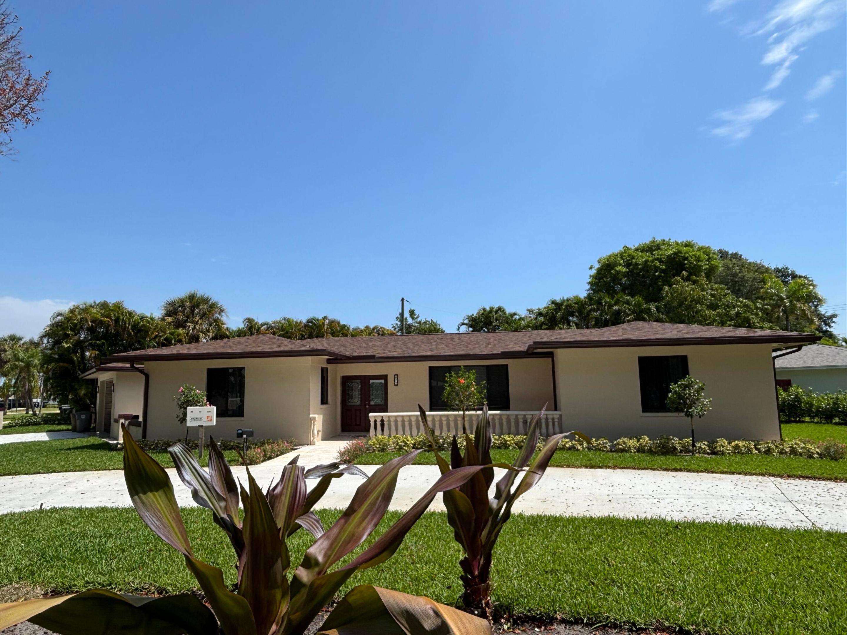 PARADISE FOUND IN THE HEART OF LAKE PARK! Welcome to 135 E Ilex Drive, Lake Park, FL 33403. This beautifully renovated home is ideally located just minutes from the Intracoastal Waterway, marinas, boating, fishing, waterfront dining, and all the best that South Florida has to offer. Completely remodeled from top to bottom, this move-in-ready property features a new roof, new A/C system, impact-resistant hurricane windows, new flooring throughout, a fully renovated bathroom, and a stunning chef's kitchen with new cabinetry, premium countertops, and brand-new stainless-steel appliances. The bright and open floor plan offers modern finishes and abundant natural light. Outside, you'll find a huge backyard with plenty of room for entertaining,  simply enjoying you
