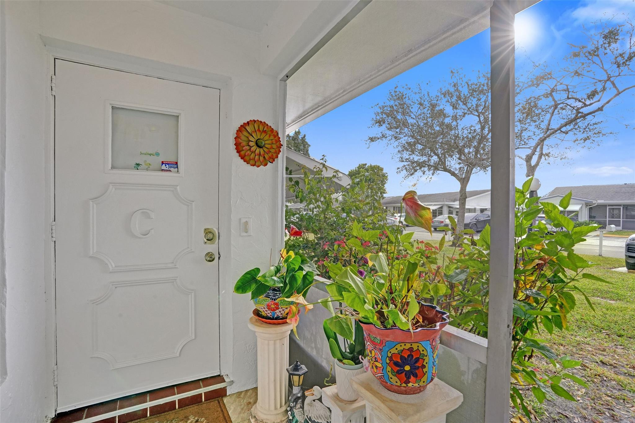 This spacious, beautifully updated villa offers modern living within a charming 4-plex layout. The home features sleek tile flooring throughout and a gourmet kitchen boasting granite countertops with a dual-access design for easy access. Both bathrooms have been custom-renovated with high-end finishes. The primary suite is a true retreat, featuring an adjacent air-conditioned flex space—perfect for a home office or private sitting room. Complete with a large laundry room featuring a utility tub and full-sized appliances, this home combines style with everyday convenience. Located less than 2 miles to Publix, shopping and dining.