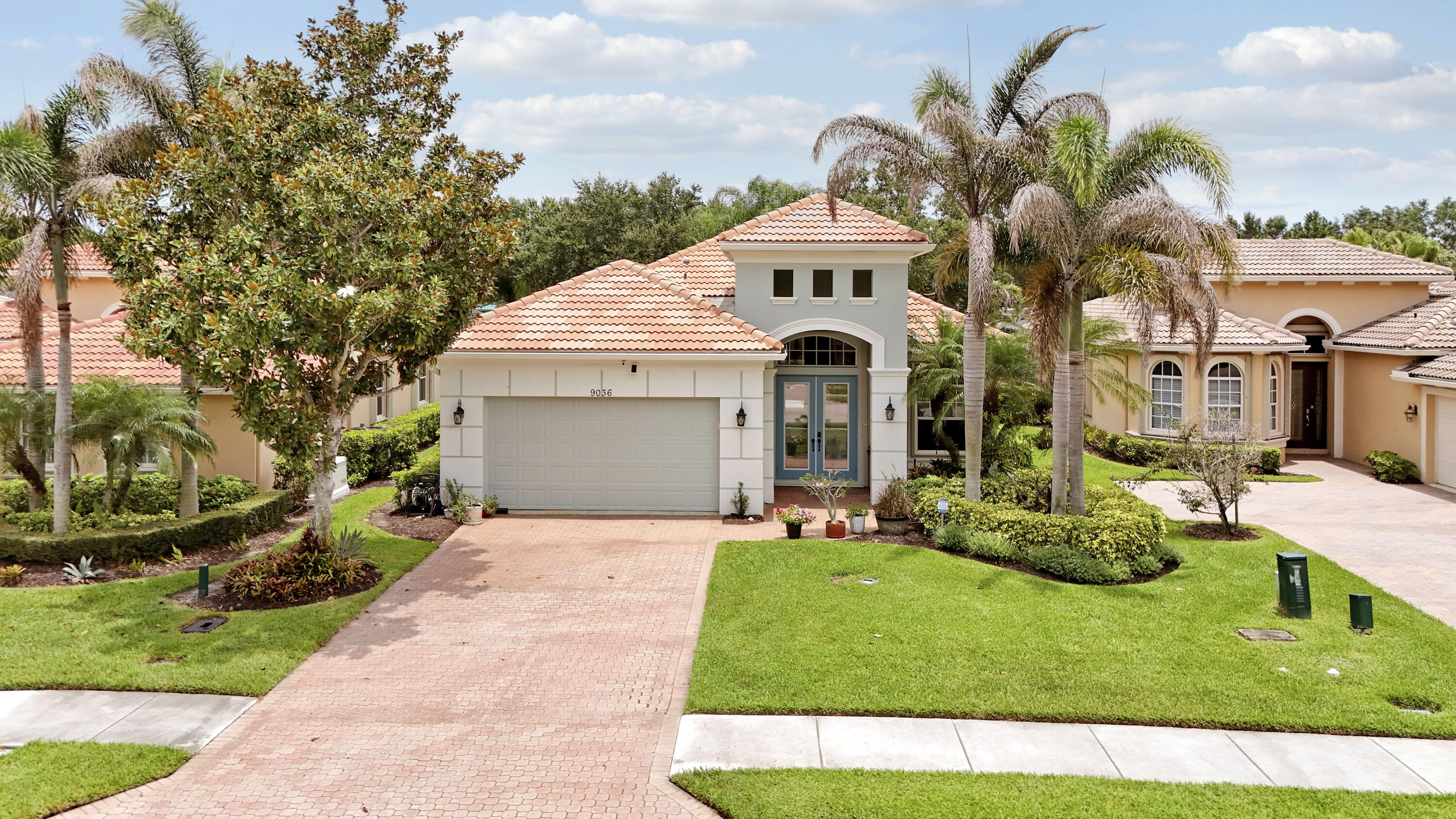 WELCOME HOME! Steps to the clubhouse from this ELEGANT 2BR+Den/2BA/2CG Deerhurst plan with private pool & spa in PGA Village is sure to impress! Special features include glass entry doors, accordion hurricane shutters, new AC (2024), new WH (2025), tile floors w/ decorative inlays, crown molding & woodwork t/o and more. Kitchen with plenty of cabinetry, including glass doors for display, quartz counters, breakfast bar & prep island, seamless single basin sink, tile backsplash & stainless appliances including Sub-Zero wine fridge! Great room has triple sliding doors with tranquil views over the pool, spa & lake beyond! Primary suite has access to patio, 2 closets with custom organizers and a SPA-LIKE ENSUITE with white cabinetry, quartz counters, dual sinks, tiled shower & soaker tub!  Guest bedroom & bathroom are down the hall & den with beautiful built-ins (including a closet) could easily be used as a 3rd bedroom. The laundry room with utility sink, cabinetry and front load washer & dryer, make it almost enjoyable to keep up with the chore! The pool & spa have been recently resurfaced and are the perfect spot to lounge, swim and enjoy. HOA dues includes lawn care, basic cable/internet, guard gated security and access to all amenities at the PGA Village 'Island Club'. This home is within walking distance to the resort-style pool, fitness center, exercise rooms, craft room, billiards, library, ballroom, tennis, pickleball, playground and more!  PGA Village an amenity rich community with COUNTY ONLY TAXES surrounded by multiple golf courses where MEMBERSHIP IS OPTIONAL. Located close to St. Lucie West with shopping, restaurants, the Mets Spring Training facility and Tradition Square. Easy access to interstates, airport, area beaches, and the communities of Vero Beach, Jensen Beach, Stuart, Jupiter & Palm Beach. Call today to view!