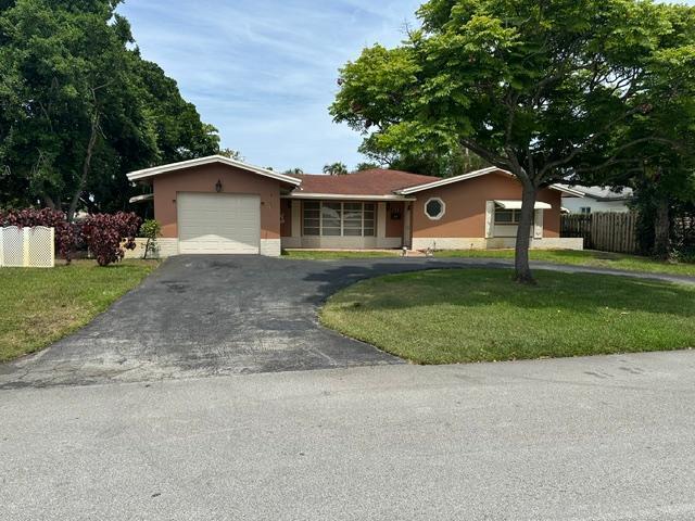 SPACIOUS 3 BEDROOM 2 BATH HOME IDEALLY LOCATED ON A LARGE CORNER LOT IN MUCH SOUGHT AFTER "THE COVE" IN DEERFIELD BEACH. BEAUTIFULLY UPDATED KITCHEN AND BATHROOMS. WALK IN CUSTOM CLOSET. KITCHEN HAS LARGE EATING AREA. L-SHAPED LIVING ROOM AND DINING AREA. VERY LONG, WIDE ROOM ACROSS THE BACK OF THE HOME, GREAT FOR ENTERTAINING OR KIDS' PLAY SPACE, OR FAMILY ROOM. ENORMOUS SCREEN ENCLOSED PATIO TO ENJOY THE PRIVATE BACK YARD. CIRCULAR DRIVEWAY THAT CAN ACCOMMODATE MANY CARS AND ONE CAR GARAGE. THIS GREAT HOME IS CONVENIENTLY LOCATED NEAR SHOPPING, RESTAURANTS, THE BEACH AND MUCH MORE.