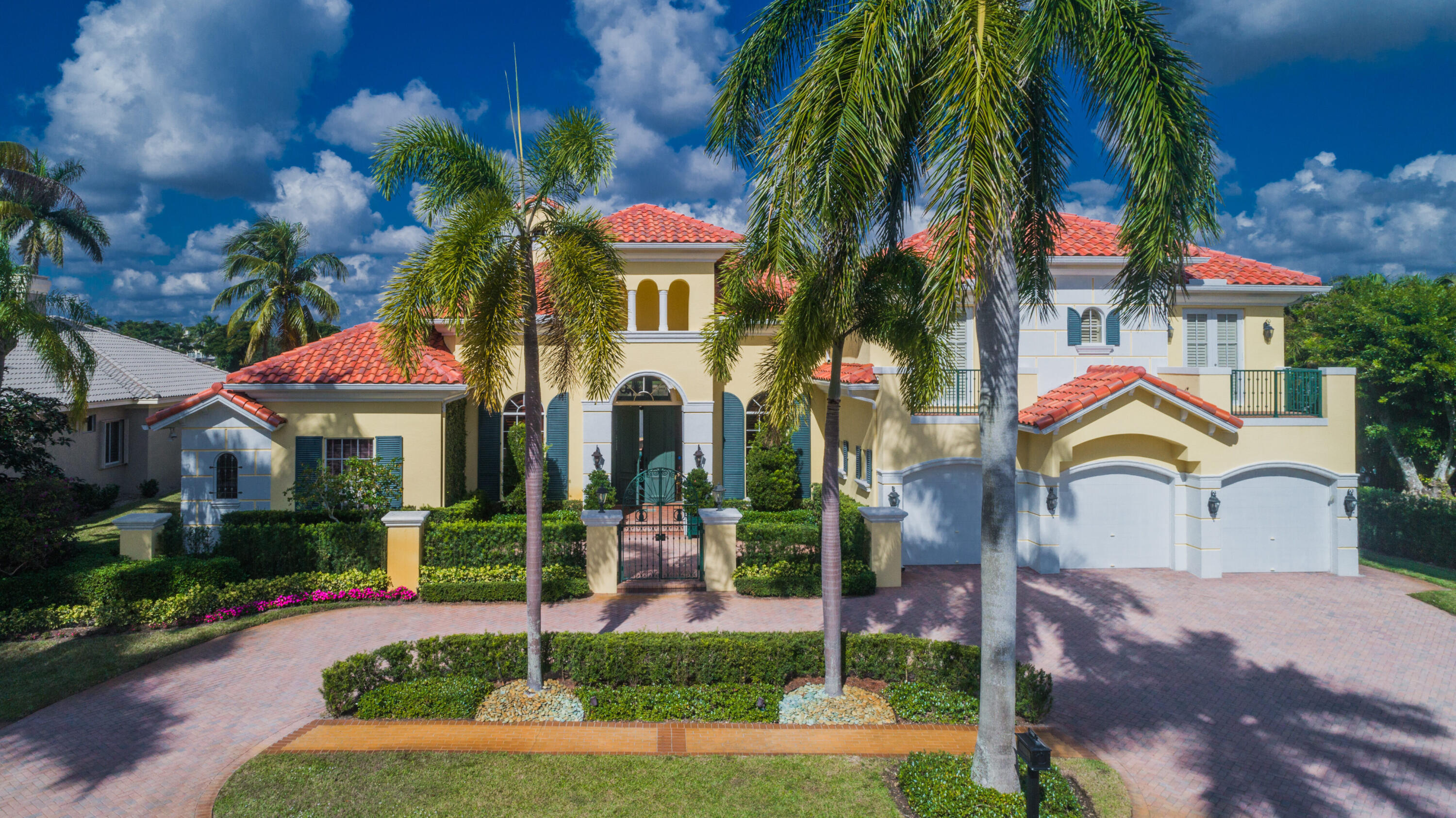 Situated on the most spectacular lake and golf course lot in St Andrews Country Club, this luxurious Palm Beach inspired estate with over 5,900 sq ft of living area with 5 bedrooms and 4.2 bathrooms features magnificent architecture, quality custom finishes and hardwood floors throughout the first floor. The first floor includes a formal living room, formal dining room, a gourmet chef's kitchen, breakfast area and large family room all designed for effortless entertaining or casual living. Also featured on the first floor is a rich wood paneled library with loft. The primary bedroom wing includes a  luxurious  bathroom, 2 spacious closets, sitting room and office.  Two en suite bedrooms complete the first floor. The second floor offers 2 bedrooms with adjoining bathroom and shared balcony.  A lushly landscaped resort-style pool, spa, and loggia with breathtaking lake vistas offers the utmost in entertainment and complete this estate. Additional features include 3 car garage, full hurricane protection on windows and doors, and new roof in 2020. The information herein is deemed reliable and subject to errors, omissions and changes without notice.  All measurements are approximate.