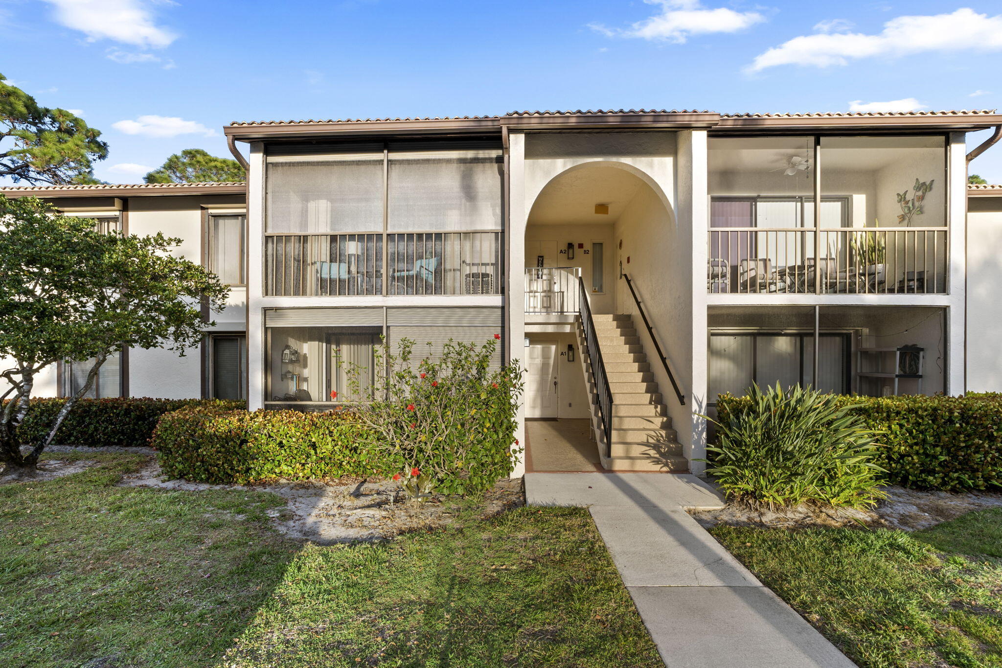 Move-in ready 3-bedroom, 2-bath second-floor condo in the gated Pine Ridge at Martin Downs community. Functional layout with a screened, tiled balcony and accordion hurricane shutters. Honey Washington Oak laminate flooring in the main living areas with carpeted bedrooms. Open living and dining area with good natural light, ample storage, new appliances, new A/C system including both the interior unit and exterior, in-unit washer and dryer, and a large walk-in closet in the primary bedroom. Pine Ridge is a gated, pet-friendly community with a heated pool, clubhouse, and tennis courts, conveniently located near top-rated schools, shopping, dining, golf, and easy access to I-95 and the Turnpike.