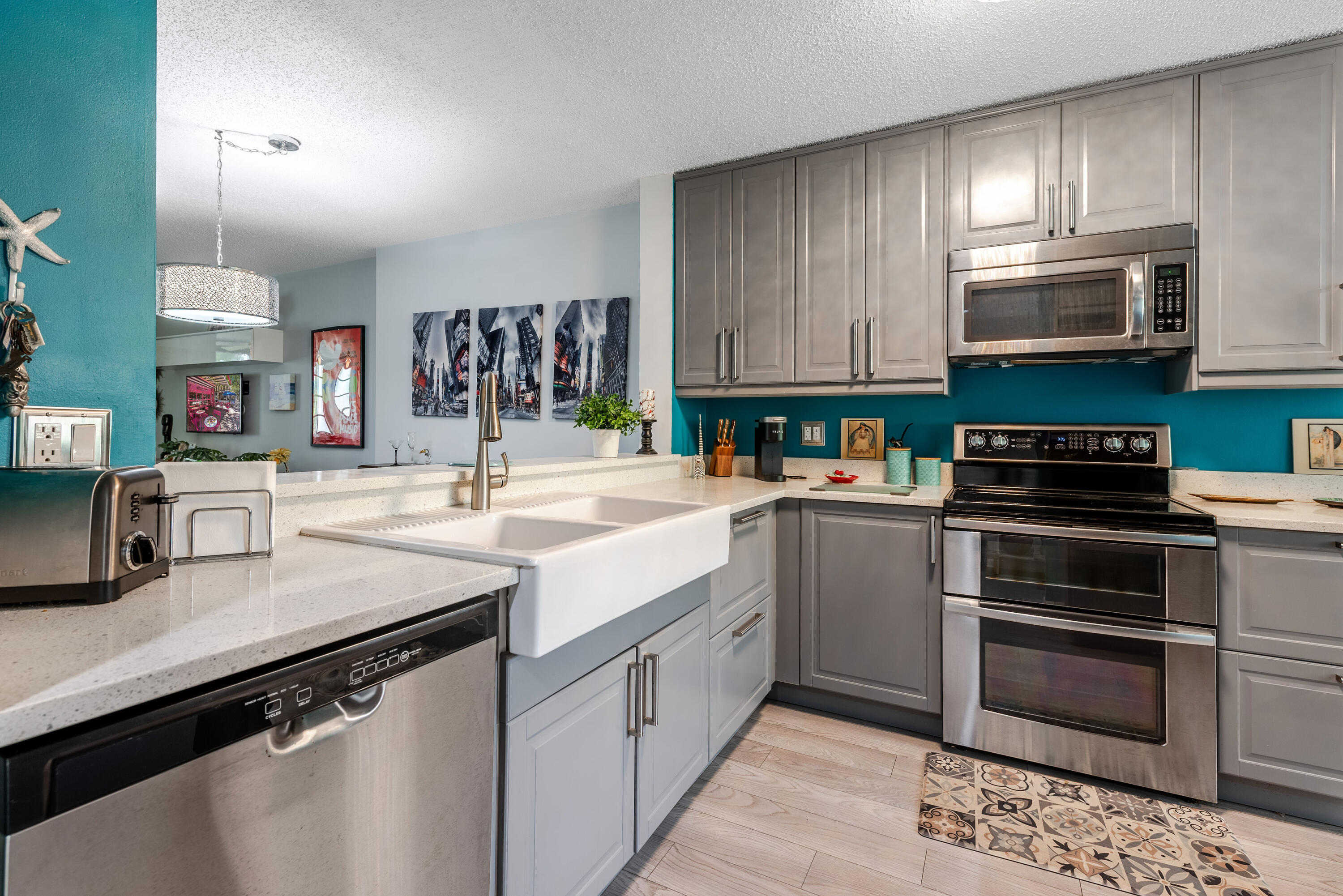 Experience the pinnacle of lakeside luxury in this beautifully renovated waterfront condominium, perfectly situated in the highly desirable Watersedge neighborhood at Lakes of Delray. Spanning 1,362 square feet of finished, bright living space within an attractive three-story building, this exceptional two-bedroom, two-bathroom residence offers an open and functional floor plan designed for modern comfort. At the heart of the home is a fully updated, curated gourmet kitchen equipped with premium countertops, elegant custom cabinetry, and high-end stainless steel appliances. Beautiful, seamless luxury vinyl plank flooring flows effortlessly throughout the main living areas, lakeside views right from your window. Living in this active adult enclave means enjoying the premier Lakes of Delray. Clubhouse features. Residents gain exclusive access to a grand ballroom, a modern fitness center, a resort-style main heated pool with a hot tub, two satellite pools, and a vibrant sports complex featuring tennis and pickleball courts.