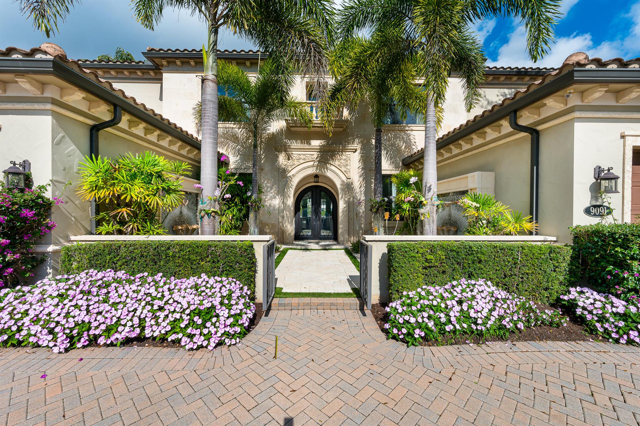 A magnificent property in The Oaks situated on a premium lakefront lot. This estate exudes luxury and sophistication as it features a dramatic entry with iron double doors, a two-story foyer adorned with a custom glass and marble staircase, and elegant marble flooring throughout most of the home. The residence includes a private downstairs guest wing with a bedroom, full bath, private entry, a club room with a built-in bar that seamlessly opens to the outdoor living area. The upstairs private primary suite is a serene retreat designed for comfort and luxury. The backyard features a summer kitchen, spa and swimming pool. Other notable features include an elevator, a 4-car garage, multiple sound systems, and a circular driveway.