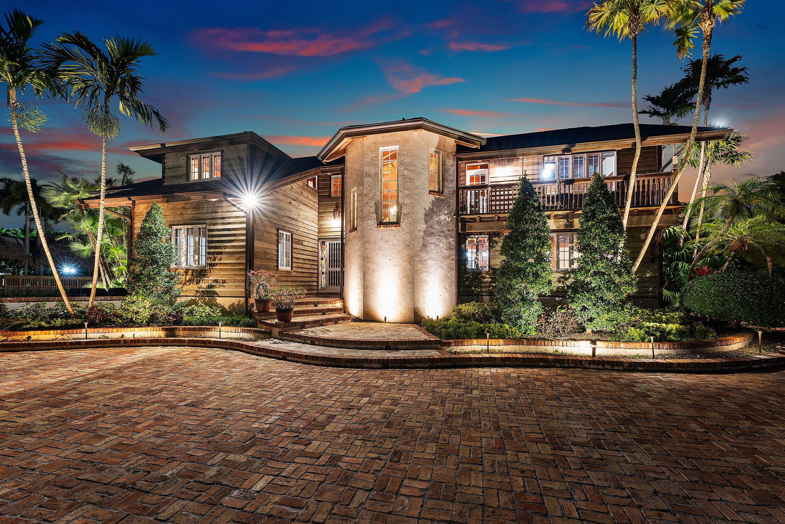 Exceptional masterpiece and private estate home located in the City of Parkland. This magnificent gated pool-home features over 1 acre of fenced-in private land with 4 bedrooms and 3 bathroom over 3,667sf of of living and total space. Private guest home consists of 2 bedrooms and 1.5 bathrooms with 1,008sf of living and total space with large storage garage. Expansive outdoor oasis with magnificent heated, saltwater pool and hot tub. Artisan stone fire pit with stone seating surrounded by expansive lush backyard. Outdoor built-in barbecue and large marble deck area perfect for entertaining around serene landscape. The property features large private pond and gazebo. This novelty home is built with authentic wood siding from the California gold sleuth's. Unique "indestructible" pressure- treated wood. Interior built of rare and exceptional Dade-County Pine, installed with unique Amish technique called Pinned and Fit. Builder spent months living and working with the Amish to perfect technique. The wood is puzzle cut and connected with pins allowing for mild flexing, withstanding virtually any storm. Wood sidings attached precisely with aligned copper nails. Home took roughly 8 years to build. All gutters run underground, to the pond in the front and a drain field in the back. Outdoor spiral staircase. Spacious and open feel with 25-foot tall ceilings and magnificent antique chandeliers. A built-in library with added charm to the loft and upper interior walk-way. Warm-welcoming fireplace opens to the dining and den areas. Pristine marble floors. Expansive island-kitchen with gold-vein countertops and stainless-steel appliances. Home has a custom roof, made with copper and original slate tiles from Virginia. Fabulous free-standing guest home was totally renovated, along with a shingle roof, updated plumbing and electric, impact windows and a tank-less water heater. This was the first structure built in the City of Parkland in 1920, and originally a hunting lodge. Exceptionally unique and historic home featured in numerous magazines. Main home features a 100-year engineered roof with forensic engineer report for insurance.