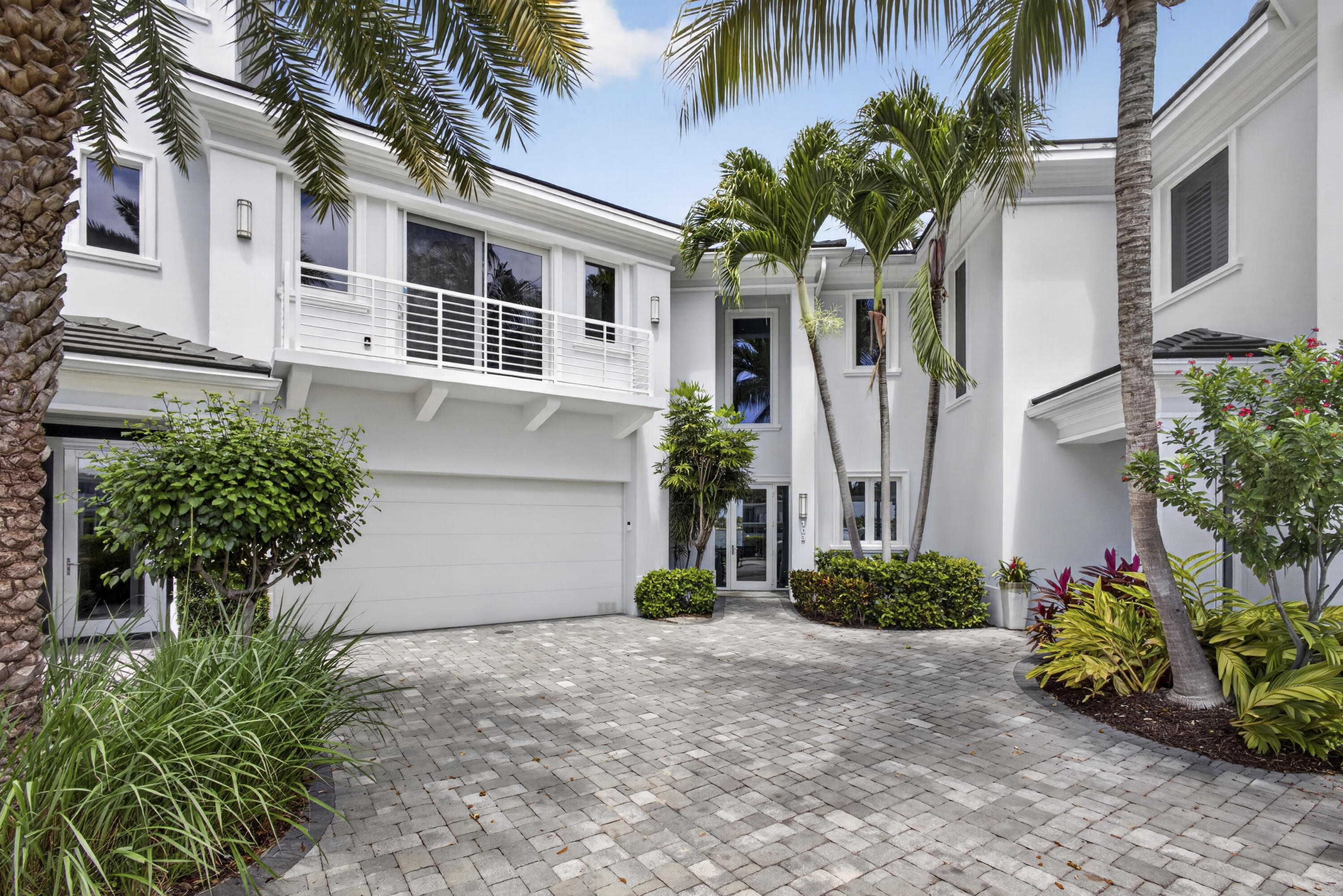 Experience elevated waterfront living in this beautifully finished 3 bedroom, 3.5 bath two-story villa at the Water Club in North Palm Beach, offering sweeping harbor and marina views and a refined coastal lifestyle. Designed by Kolter Homes and professionally decorated, this residence combines modern elegance with relaxed comfort in one of the area's most sought-after luxury waterfront communities. Light-filled interiors showcase sleek porcelain tile and warm oak flooring, a dramatic glass-enclosed stairwell, and custom built-ins that maximize style and storage. The open-concept main level is oriented to capture the water views and create an easy flow for everyday living and entertaining.  A chef-inspired kitchen features an induction cooktop, premium appliances, ample cabinetry, and a wine cooler, making it ideal for cooking and hosting. Indoor-outdoor living is a highlight, with private terraces and a spacious outdoor patio that includes a new summer kitchen, perfect for al fresco dining, lounging, and entertaining against the backdrop of the marina. Large sliding doors enhance natural light and connect the interior seamlessly to the outdoor spaces. Upstairs, the primary suite offers a private terrace with panoramic water views, a luxurious bath with high-end finishes, and generous closet space. Two additional ensuite bedrooms provide comfort and privacy for guests or flexible use as an office or den. A stylish, well-appointed laundry room on the second level adds everyday convenience.  Residents of Water Club North Palm Beach enjoy a resort-style lifestyle with access to two state-of-the-art fitness centers, two elegant resident club rooms, three sparkling pools, fire-pit seating areas, and day docks with direct Intracoastal Waterway access. Guest suites within the community provide an excellent option for hosting visitors. The gated, amenity-rich setting, combined with its prime waterfront location, offers an exceptional opportunity for luxury coastal living close to boating, beaches, dining, shopping, and golf.  This villa at Water Club North Palm Beach delivers a rare blend of modern design, indoor-outdoor living, and full-service amenities in a premier waterfront community, ideal as a primary residence or lock-and-leave retreat.