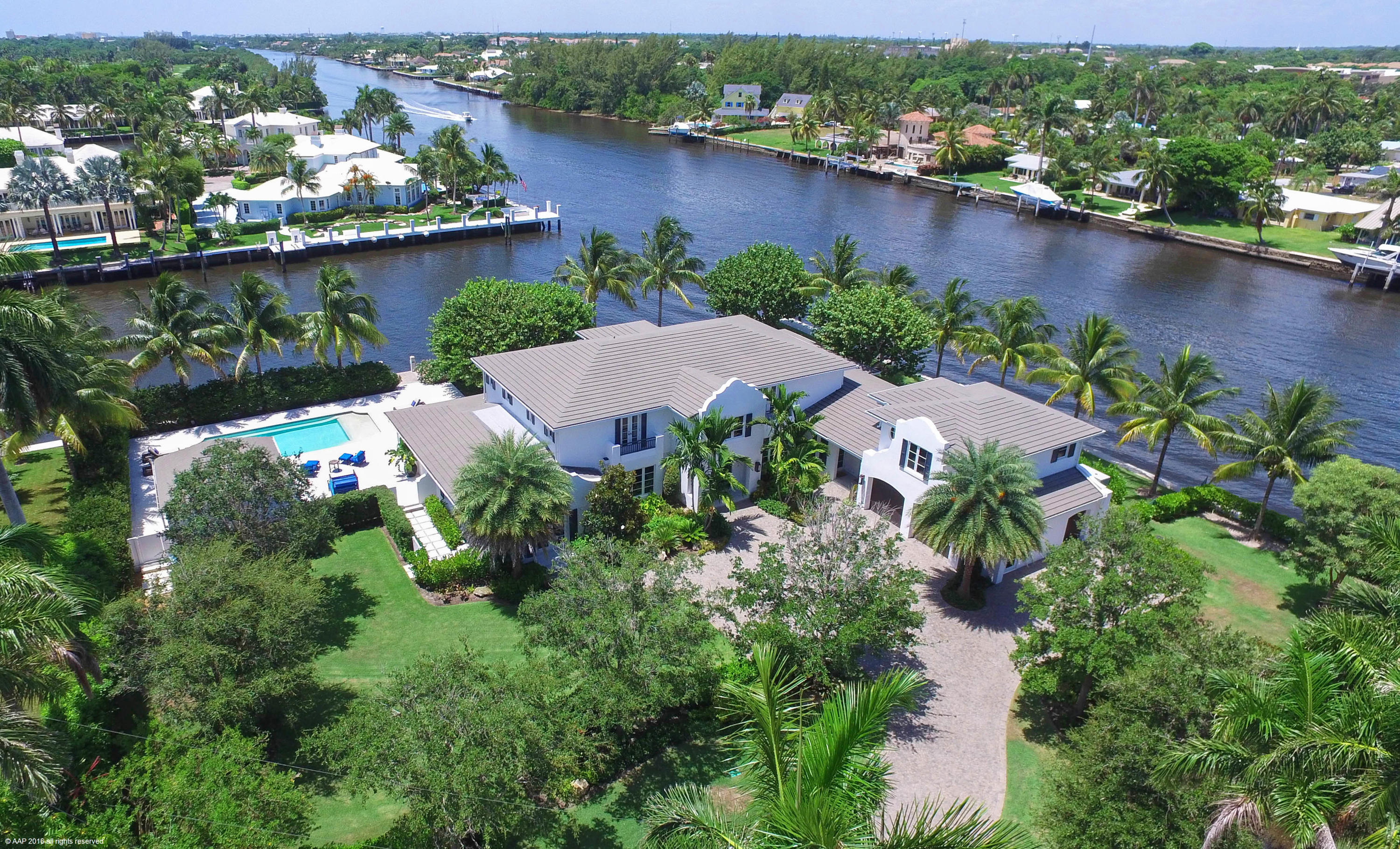 Point Lot Estate Commanding 411 feet of Waterfrontage. Staged against the sparkling Intracoastal this 9,600 total square foot Point Lot Estate is sited on 411 feet of water frontage.  Completely re-designed from top to bottom in 2014 the meticulous finishes and superb craftsmanship are evident in every detail. The home offers 5 bedrooms seven plus baths, a self-contained guest apartment with large living and kitchen area accommodating friends and family with prized private space. Upon arrival guests are greeted with a gracious staircase leading to a magnificent master suite with his/her bathrooms, three additional guest suite, all with water views, plus a workout room. Encompassing the first floor is a lovely living room with fireplace, an oversized dining room and a cozy sitting area. A gourmet kitchen suited to the best of chef's where informal meals may be enjoyed in a large breakfast area surrounded by water. Adjacent to the kitchen is a magnificent family room with cathedral callings, large windows affording lots of light and sweeping water views. Completing the first floor is a private office,   a game room which flows to two private terraces, large pool and dock all inviting spirited outdoor entertainment. The estate is surrounded by an oasis of   lush tropical landscaping bestowing supreme serenity with broad vistas reflecting the synergy of water and nature. Close to the fabulous Atlantic Ocean and Atlantic Avenue.  Don't miss this opportunity !!