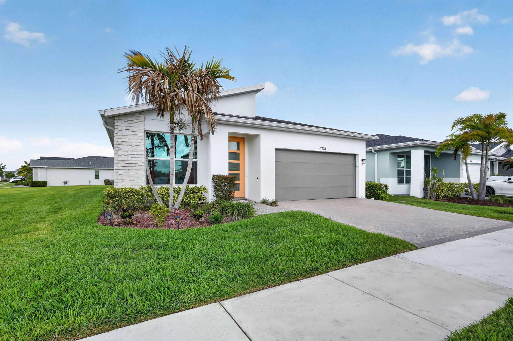 Built in 2022, this stylish 3-bedroom plus den/office, 2.5-bath, 2-car garage home offers modern comfort in the sought-after Tradition area. Designed for today's lifestyle, the home features a crisp white kitchen with quartz countertops, stainless steel appliances, gas range, spacious pantry, and a large island with space for seating. The open-concept layout is enhanced by wood-look tile flooring, abundant natural light, and a laundry room with utility sink. Relax on the covered, screened patio with a peaceful glimpse of the pond. Situated on a corner lot within a gated community with a pool and gym, residents enjoy convenient access to nearby shopping, dining, and Tradition's vibrant Town Square. Move-in ready and attractively positioned, this is an exceptional opportunity. An added bonus—this established neighborhood is fully built out with no immediate nearby construction. Why wait for your vacation lifestyle to begin?