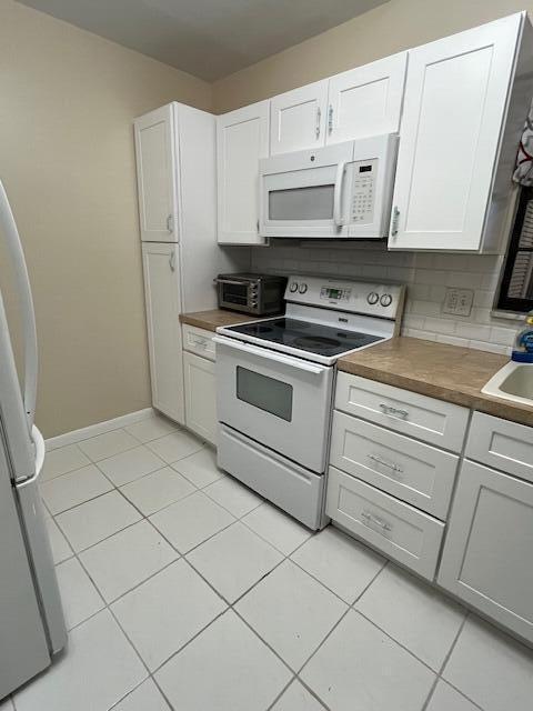 *JUST REDUCED*..Beautiful 3 bed/ 2 Bath corner unit on the 1st floor located in the desirable ALL AGES community of Pebble Springs. Over 1200 sf. of living area with NEWLY INSTALLED IMPACT WINDOWS AND DOORS. Spacious unit with a lovely  view of the Bridges of Springtree Golf Course from the Living Rm & Master Bedroom. This will be a perfect home for your Buyers! Large kitchen with breakfast counter. 3 Walk In Closets provide ample room for everyone! Newer Elecrical Panel. Newly tiled rear patio. Outdoor back patio with tons of space to entertain and enjoy parties or just relaxing . Full sized Maytag washer and dryer located in the huge enclosed front patio with great space to use as a den or office. 2 Assigned Parking Spaces and plenty of guest parking. Low Association fee.