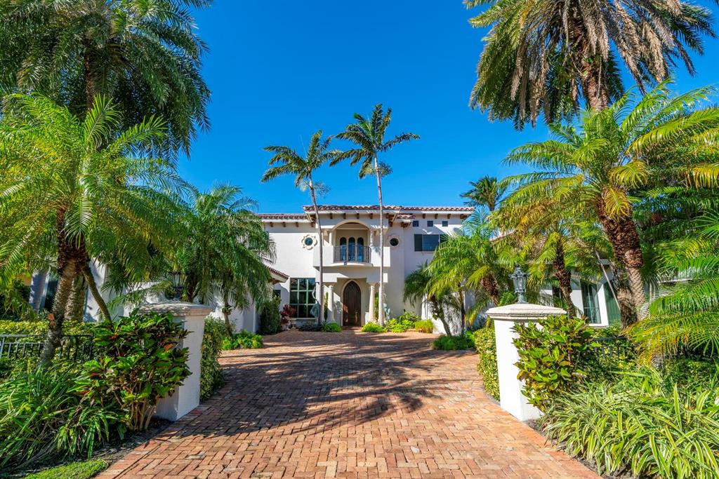 Experience quintessential South Florida waterfront living in this magnificent Intracoastal Estate, with 96+ feet of direct frontage ideally situated in a No Wake Zone, just a short boat ride to Lake Boca, the Boca inlet and the crystal waters of the Atlantic Ocean. Enter the elegant mediterranean inspired estate and you are immediately greeted with stunning views of the bright and open living room with floor to ceiling windows framing the infinity pool and waterway beyond. Designed for lavish indoor/outdoor entertaining, the home's expansive family room features dramatic glass sliders that open to the poolside loggia with Summer Kitchen and resort style infinity pool with spa. Retreat to the spacious master suite with intricately carved fireplace, private office, sitting room, oversized his and hers closets and baths and panoramic views overlooking the water. This impressive 5 BR, 7.2BA home boasts a formal dining room with Venetian plastered walls, a stately den with hardwood floors and built-in shelving, a fitness room and media room. Highlighted interior features include elevator, first and second floor Laundry rooms and second floor loft complete with wet bar. Set in the charming beachside enclave of Riviera, steps away from the pristine beaches and the boutiques and eateries of Mizner Park and Palmetto Park Road, residents can enjoy all the charms of a pedestrian lifestyle.