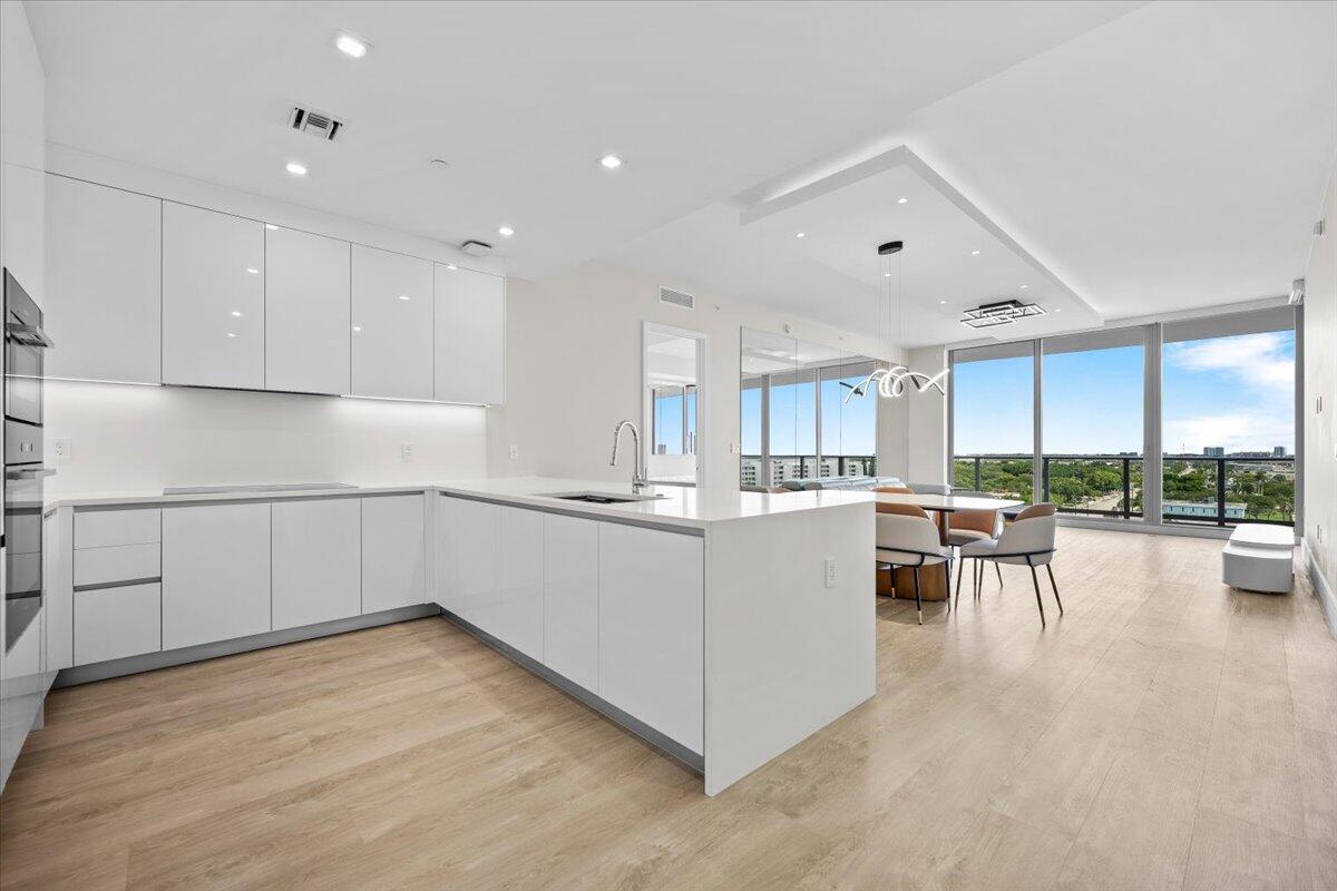 Newly completed, designer-furnished residence at Nautilus 220 featuring  $300,000 in upgrades, custom improvements, designer furnishings, and curated finishes, ready for immediate move-in. This open-concept home offers soaring 10-foot ceilings, refined finishes, and a seamless blend of luxury and functionality.  The chef's kitchen showcases premium Miele appliances, a dedicated beverage cooler, & a waterfall quartz island. Custom-designed closets, designer lighting, and thoughtful upgrades elevate every space throughout the residence. The primary suite offers a spa-inspired bath, bespoke storage, and access to a private terrace with tranquil water views.  A rare and valuable offering, this residence includes two garage parking spaces.  Nautilus 220 offers an unmatched resort lifestyle Life at Nautilus 220 feels like a permanent vacation with access to a one-acre amenity deck, resort-style pools and spas, a rooftop lap pool, and high-end fitness and yoga studios. Indulge in the sauna and steam rooms, or find entertainment at the private bowling alley and sports simulator. Beyond the building's lounges and private beach club access, residents can enjoy world-class waterfront dining at SeaHawk Prime by David Burke right on-site. This is a unique opportunity to step into a fully realized, designer-clad lifestyle.