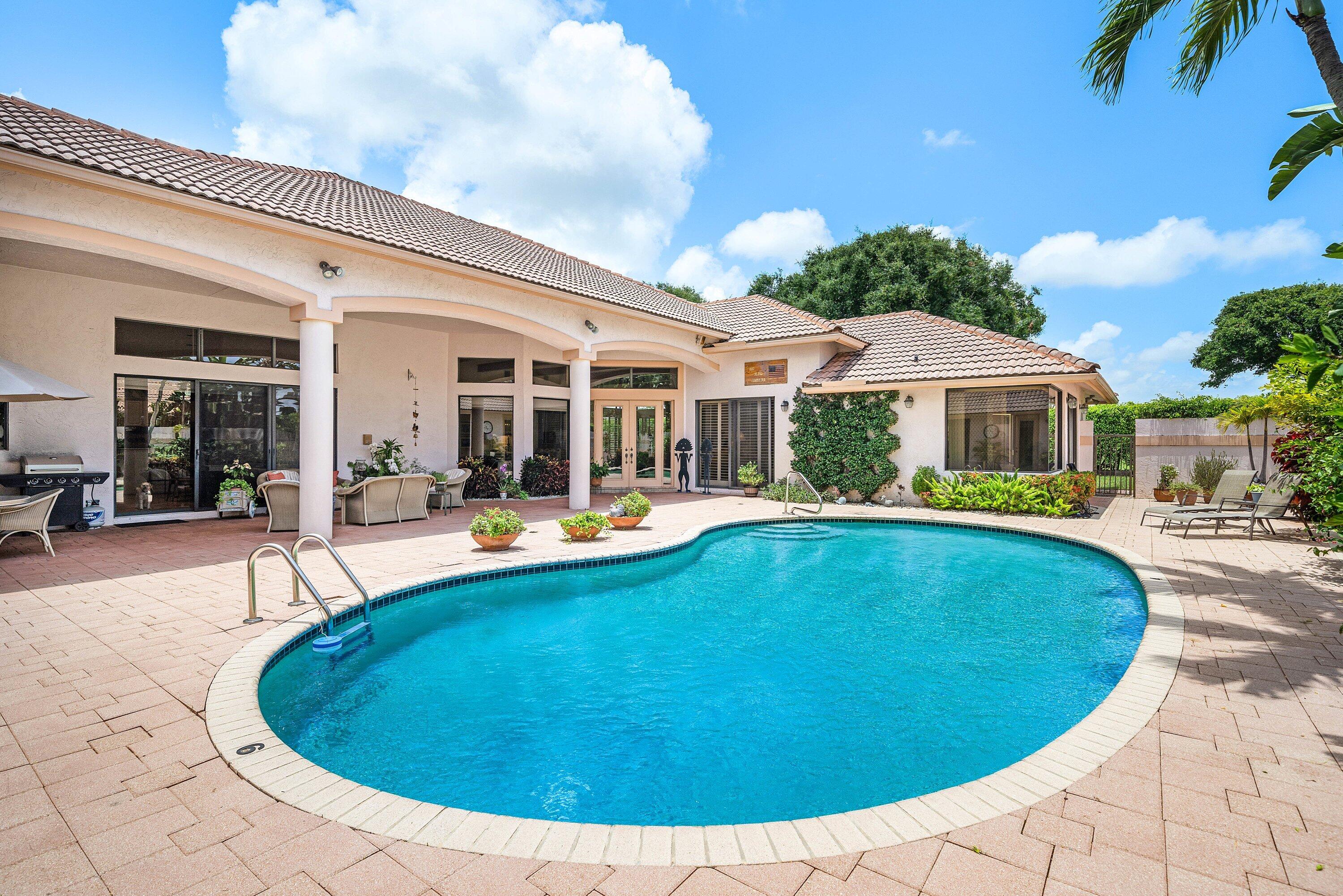 Nestled within the prestigious gates of Bocaire Country Club, this spacious and expansive courtyard residence offers the perfect blend of elegance, comfort, and South Florida luxury living. Situated on a beautifully landscaped oversized lot, this exceptional home welcomes you with soaring ceilings, abundant natural light, and an effortless indoor-outdoor flow designed for both grand entertaining and everyday relaxation.  The thoughtfully designed floor plan features generously sized living spaces, multiple entertaining areas, and a private courtyard setting that creates a tranquil resort-style atmosphere. The expansive primary suite offers a luxurious retreat with spa-inspired baths, oversized walk-in closets, and serene garden views.  Additional guest suites provide comfort and privacy for family and visitors alike.  Step outside to enjoy the private courtyard, open patio areas, and lush tropical surroundings, creating the ideal setting for entertaining or quiet relaxation. Whether hosting guests or enjoying peaceful mornings at home, this residence embodies the best of Boca Raton country club living.  Located in the prestigious Bocaire Country Club community, residents enjoy access to championship golf, tennis, pickleball, fitness amenities, fine dining, and an intimate boutique club lifestyle just minutes from Boca Raton's finest shopping, dining, beaches, and airports.