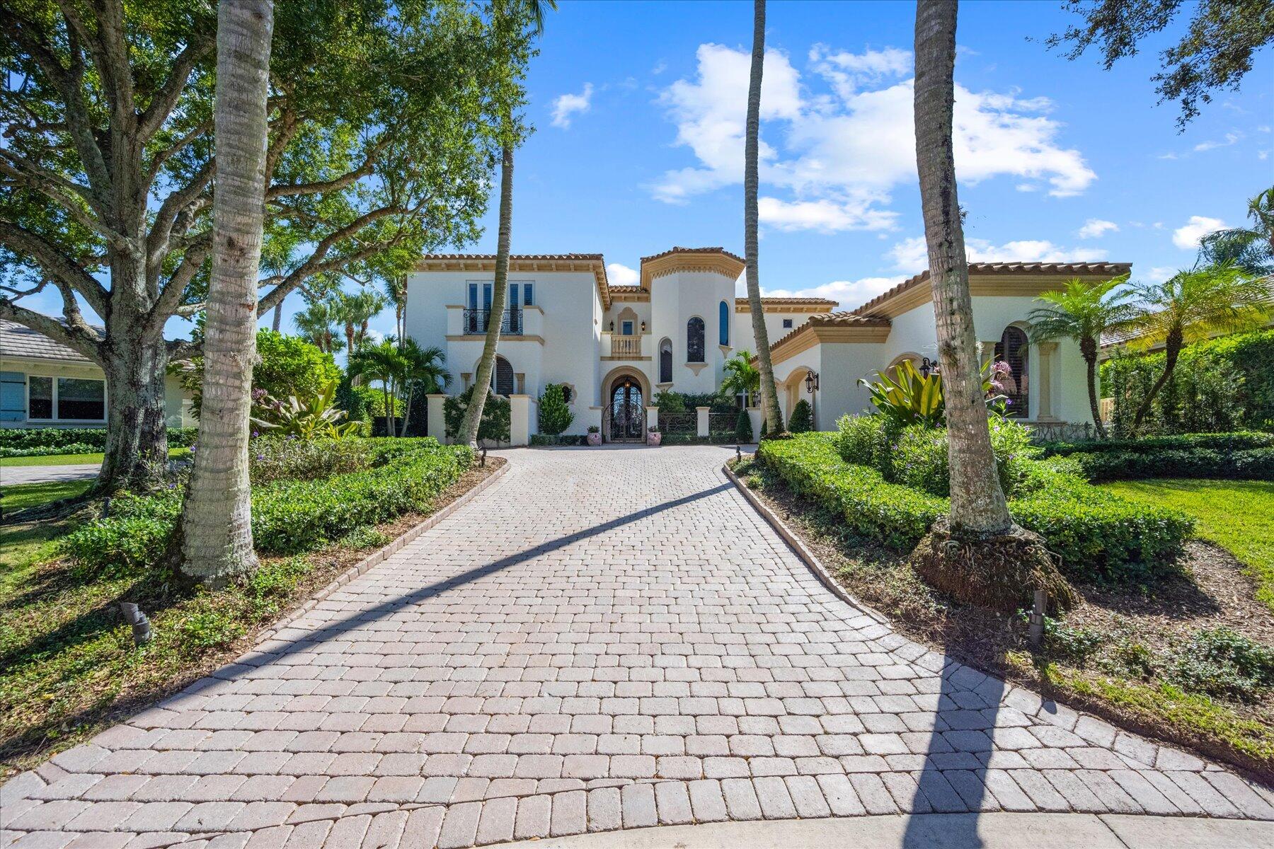 Located behind the private gates of the award winning Loxahatchee Club in Jupiter Florida, this pristine estate is located on a private cul-de-sac on approximately ½ lake front acre with stunning panoramic views of the lake and Jack Nicklaus Signature golf course. This home was completely remodeled in 2020 and designed and built with impressive details such as high-beamed ceilings, French doors, and exquisite custom cabinetry. The home's open plan and indoor-outdoor flow allow for both luxurious intimacy and large gatherings. Arched windows and doorways provide stunning sightlines. The living room, family room, and chef inspired kitchen, offer gorgeous views and direct access to the pool terrace through French doors. The luxurious master suite has his and hers baths, spacious closets, and private office overlooking the lake and golf vistas. Additional features include a formal dining room, 3 large guest bedrooms each with en-suite bathrooms, entertainment loft overlooking lake and golf course, and upstairs game room/study with custom cabinetry and private balcony. This property is professionally landscaped and includes infinity pool, outdoor kitchen, and fire place. The garage provides space for 2 cars and a golf cart.