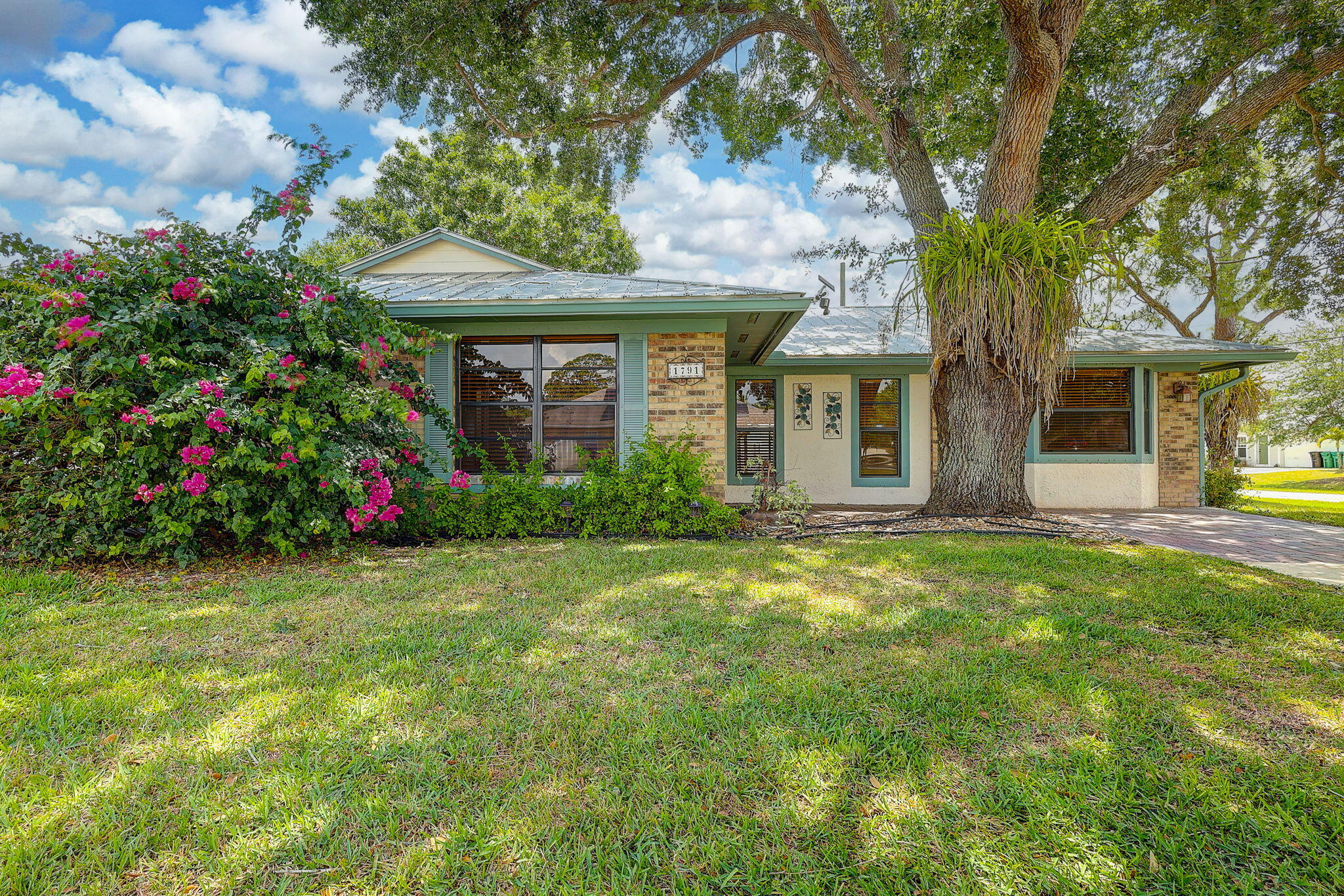 Charming 3/2 exudes warm country character and effortless everyday comfortable living. The heart of the home is the renovated designer kitchen with SS appliances and a cozy window reading nook-perfect for morning coffee or weekly menu planning. Outdoors, enjoy a true entertainer's retreat with a pergola trimmed with soft ambient lighting and a fire pit, perfect for memorable get togethers and relaxing evenings. 2024:  New AC & Water Heater. 2025: New bedroom carpets & New window screens. Large Shed with power and refrigerator. Metal roof. Side fence has an entrance for a boat/truck/trailer.