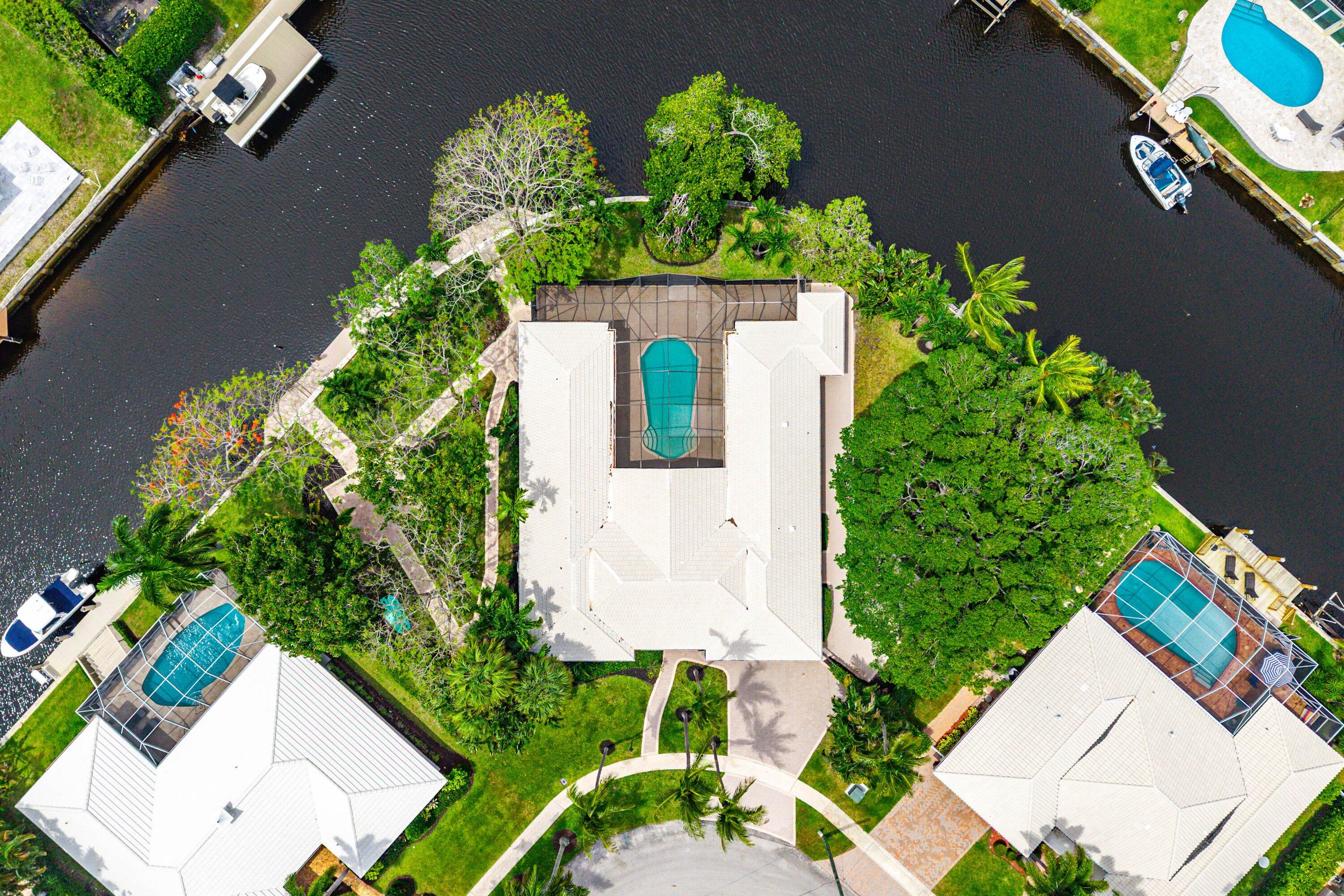 Don't miss the opportunity to own this rare trophy lot in Camino Gardens!  Owning a house in East Boca with a lot size of almost 1/2 an acre is a once in a lifetime opportunity.  This pie shaped point lot offers privacy and wide water views from almost every room in the house.  The house is currently a 3/3 and 3184 squ ft with plenty of land to create your own private retreat. . .  the possibilities are endless.  This waterfront double lot boasts 260 feet of water frontage including a 90 foot dock with composite decking.  Direct ocean access with fixed bridges.    A+ Schools, Golfcart/Bike/walk to downtown Mizner, Beach or Boca Inlet.  Take advantage of this rare opportunity to create a private oasis in the prestigious East Boca neighborhood of Camino Gardens. . .