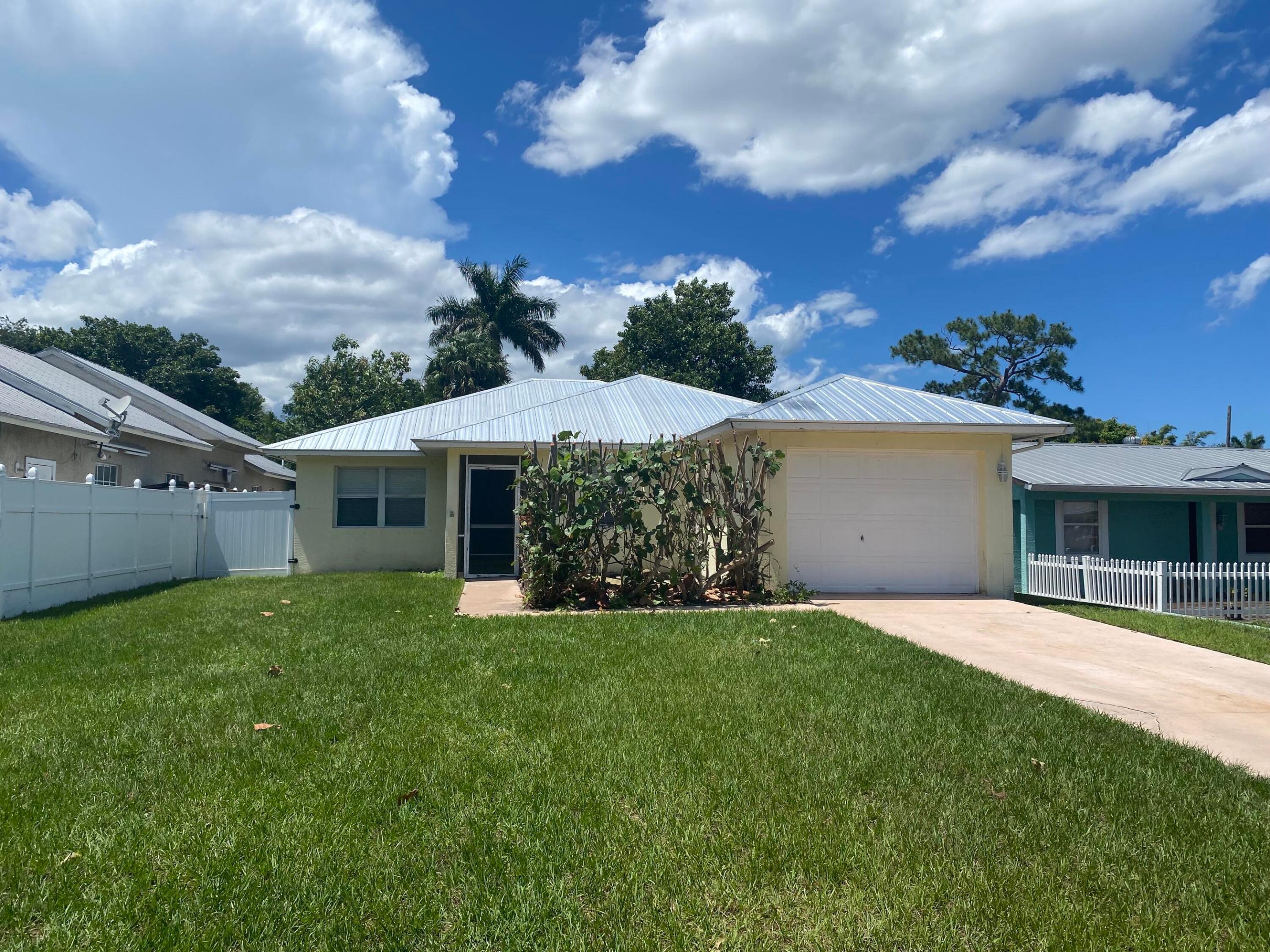 3-bedroom, 2-bath CBS home with additional separate office/study space in Palm City. Metal roof installed in October 2020, AC in September 2024. New waterproof flooring in the entire house, new kitchen pantry, newer appliances. Freshly painted with beautiful wainscoting. AC is on a 5 year warranty covering parts and labor to ensure your worry free summer days. Fully fenced back yard with a newer deck. Recent 4-point inspection report is available if required. Prime location, no HOA, close to everything in Palm City. The house is located close to I-95 and the Turnpike, as well as A-rated schools.
