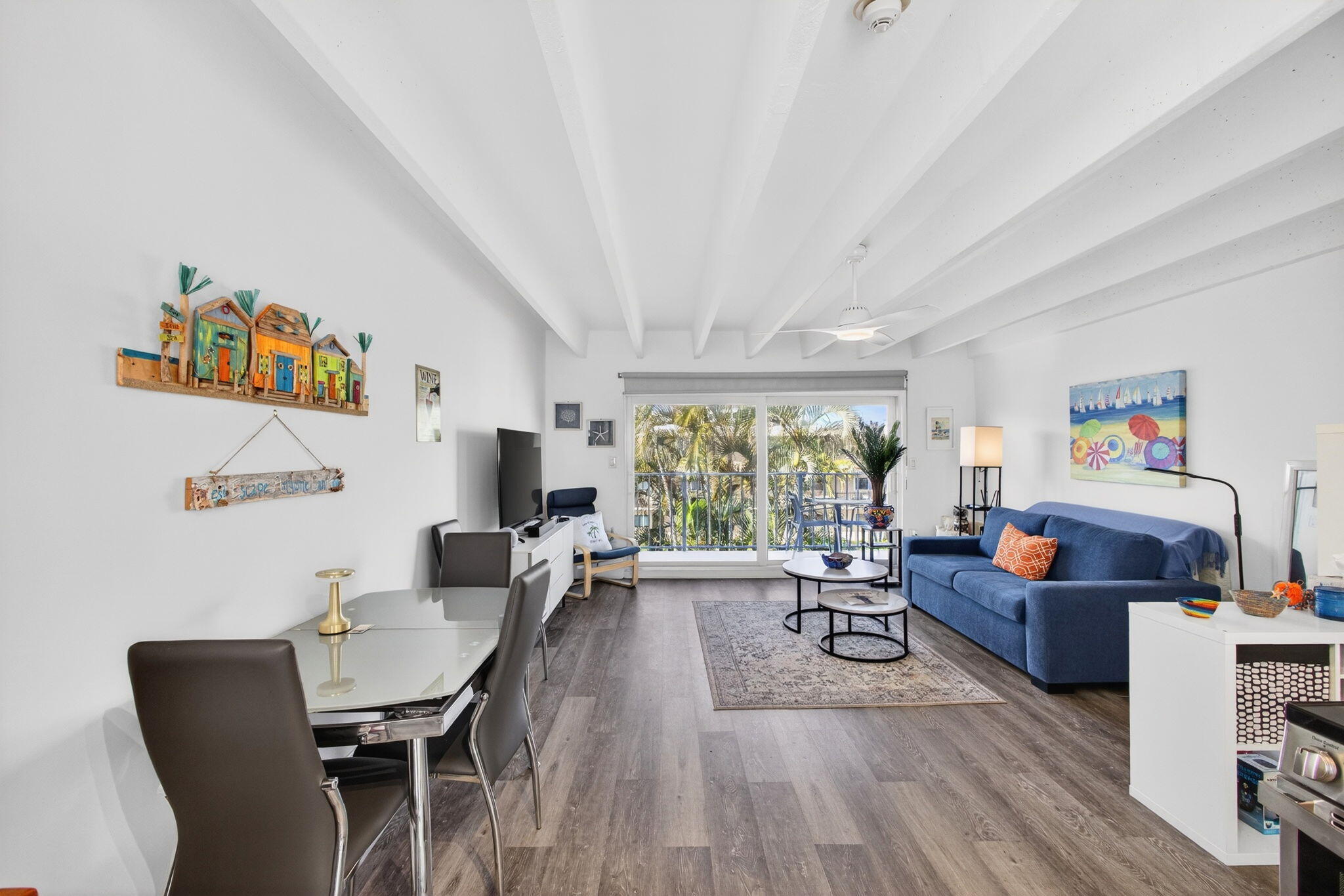 Welcome to your beach getaway! This bright, top-floor studio at Tropicana Gardens in South Palm Beach  is clean, turnkey & features modern finishes. Recent updates include the bathroom vanity, modern lighting fixtures & fans & luxury vinyl flooring. Impact door & impact glass throughout provides storm protection & noise protection. The fully renovated kitchen boasts white quartz stone & stainless-steel appliances. Tropicana Gardens is a 55+ building that is very well-maintained, past Milestone Inspections, fully reserved & highlighted by a heated pool on the Intracoastal. A large extra storage locker provides valuable additional space. The community handyman is fantastic. The assigned parking spot is super convenient to the unit, which can be reached via stairs or elevator. This building is in a prime location at the base of the Strip, with fantastic proximity to: Lantana Beach & Dune Deck Café, across the street; The Eau Resort; Plaza del Mar Shopping Center with Publix, Thaikyo, Art Basil, Ice Cream Club & John G's; Lantana Nature Preserve.