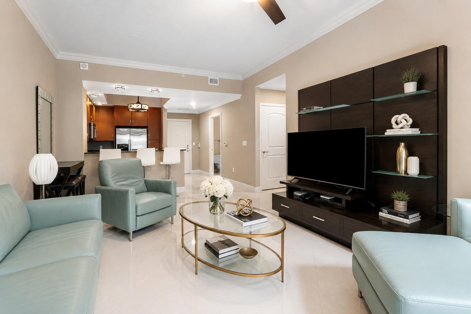 Experience effortless downtown living in this beautifully furnished 1-bedroom, 1.5-bath residence at Two City Plaza. Offering 879 square feet of thoughtfully designed living space, this inviting home features soaring ceilings, an oversized primary suite with a spacious bath, and a convenient powder room for guests. The open-concept kitchen is appointed with expansive countertops and abundant cabinetry. The breakfast bar that flows seamlessly into the living and dining areas. Floor-to-ceiling sliding glass doors lead to an extended covered balcony overlooking the building's lush gardens, fountains, and tranquil courtyard—creating a private outdoor retreat rarely found in downtown condominiums. Offered fully furnished, this residence is move-in ready and ideal as a corporate apartment,  seasonal residence, or sophisticated pied-à-terre. The oversized bedroom provides ample space for a sitting area or workspace, while the bright interior and high ceilings enhance the home's spacious feel. Perfectly positioned directly across from One Flagler and just minutes to Palm Beach Island, Brightline, airport, top dining, shopping, and nearby hospitals, this location delivers unmatched accessibility. Residents enjoy an amenity-driven, full-service building with resort-style offerings and 24-hour service—bringing convenience, security, and lifestyle together in one of downtown's most sought-after addresses. Amenities are endless; 24-hr security, concierge, roof top pool with towel service, hot tub, sauna, steam room, fully renovated state of the art fitness center/gym, massage and therapy rooms, outdoor kitchen w/ BBQ area and Restoration Hardware furniture, outdoor & indoor movie theaters, renovated club room, table tennis, lanai courtyard w/ water feature, renovated roof top dog park area, complimentary valet parking & exceptional staff. Centrally located in the heart of Downtown.