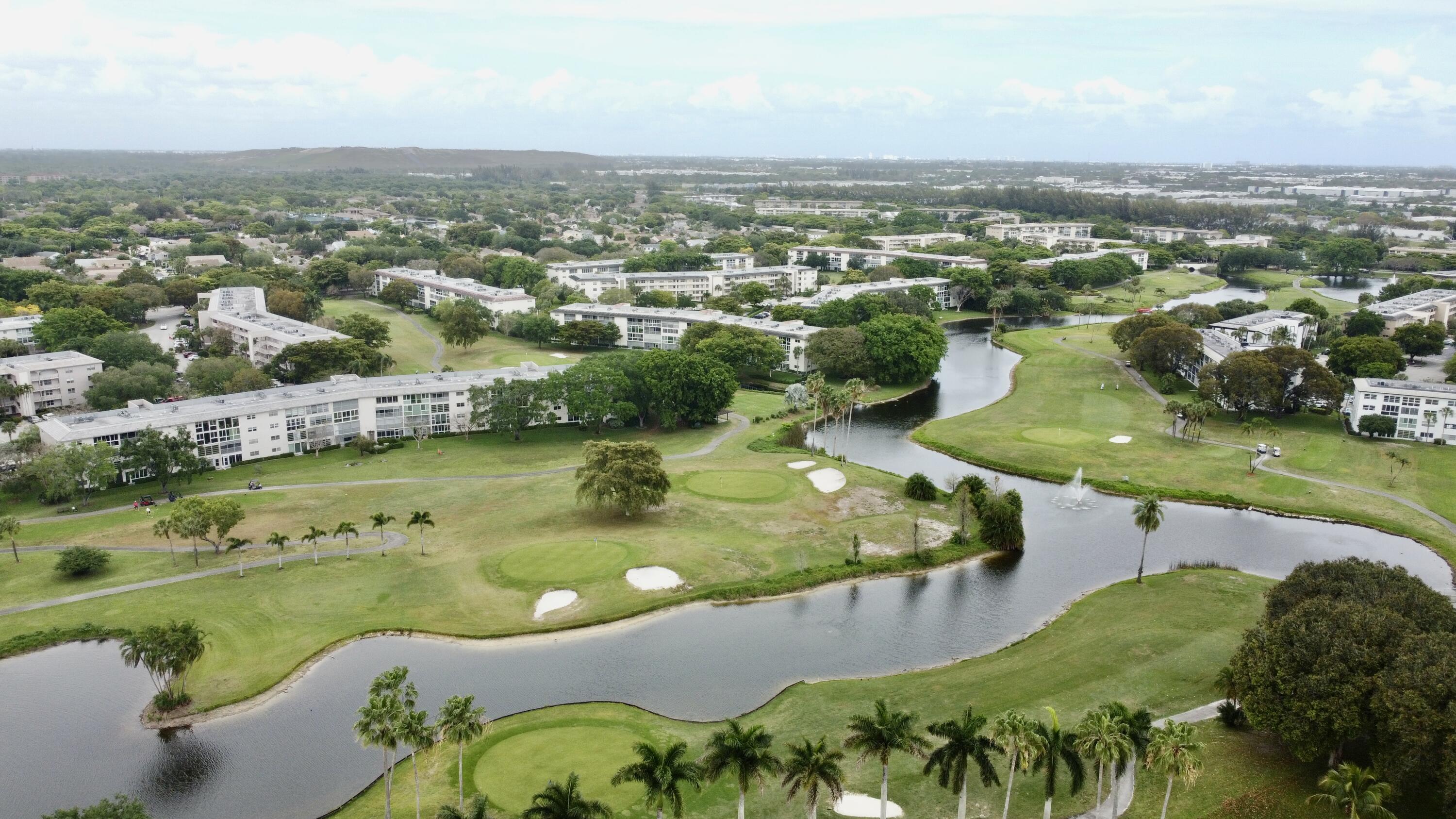 Experience the Country Club Lifestyle without the price! Beautifully defined residence offering a rare combination of expansive, direct golf & serene lake views. Enjoy breathtaking scenery from your private, spacious balcony overlooking lush greenery. The interior has been completely renovated to blend modern elegance w/ comfortable living, featuring high-end finishes & a bright open floor plan. The primary suite serves as a peaceful retreat with stunning golf views, while the chefs kitchen is equally impressive w/ no expense spared. Residents in this active 55 + community enjoy refreshing pools, BBQ area, clubhouse restaurant, playhouse, state of the art fitness center, & tranquil walking paths. Enjoy every convenience South Florida offers. This home is COMPLETELY TURNKEY! Relax & Enjoy!