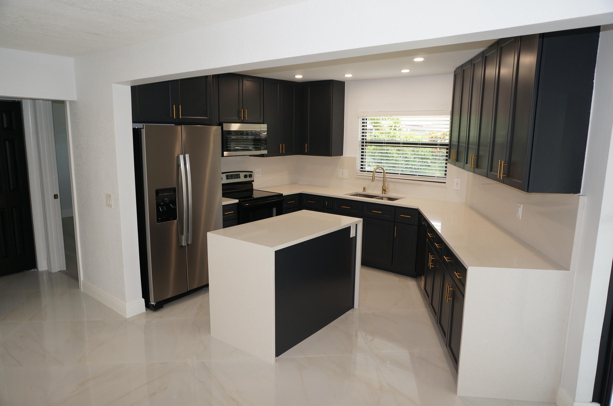 Beautifully remodeled 3-bedroom, 2-bathroom single-family home featuring modern upgrades throughout. Enjoy peace of mind with a new roof, hurricane-impact windows, and a hurricane-impact front door. The open-concept layout creates a bright and spacious living area, perfect for everyday living and entertaining. The fully renovated kitchen boasts quartz countertops, stainless steel appliances, and ample cabinet space. A large sliding glass door opens completely, seamlessly connecting indoor and outdoor spaces for the ultimate entertaining experience. Additional features include tile and vinyl flooring throughout, an automatic sprinkler system, and stylish finishes in every room. Move-in ready and designed for comfort, convenience, and Florida living at its best. Property has been fully remodeled and is move-in ready. Improvements include new roof, hurricane-impact windows and front entry door, remodeled kitchen with quartz countertops and stainless steel appliances, updated flooring throughout with tile and vinyl, and an automatic sprinkler system. Open-concept floor plan offers excellent flow between living, dining, and kitchen areas. Oversized sliding glass door fully opens to create an ideal indoor-outdoor entertaining space. Buyer to verify all measurements, permits, and property information. Easy to show.