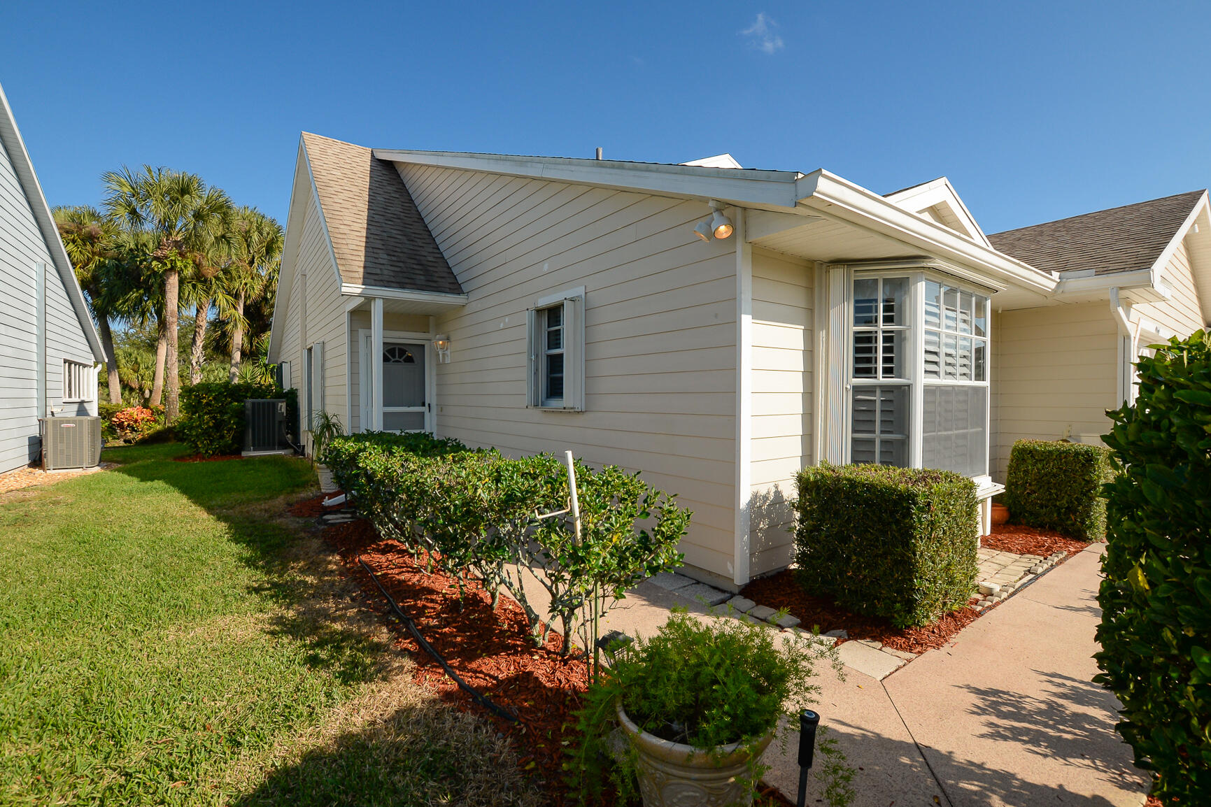 Welcome to a carefree lifestyle in this beautifully maintained 2 bedroom 2 bath villa located in The Garden Villas at Gator Trace Golf and Country Club. This quiet friendly neighborhood surrounded by nature offers peace and tranquility. Home features a bright open floorplan, newer appliances and tasteful interior updates throughout. Relax on your private patio and enjoy sunrises and golf course views; perfect for morning coffee or unwinding after a day on the greens. The primary suite offers generous closet space and an en-suite bath featuring dual sinks and a step-in tiled shower, while the guest bedroom & bath provide comfort for visitors. The community pool, on-site restaurant & bar add the finishing touches. Just minutes from area beaches, waterfront dining, shopping, & entertainment.