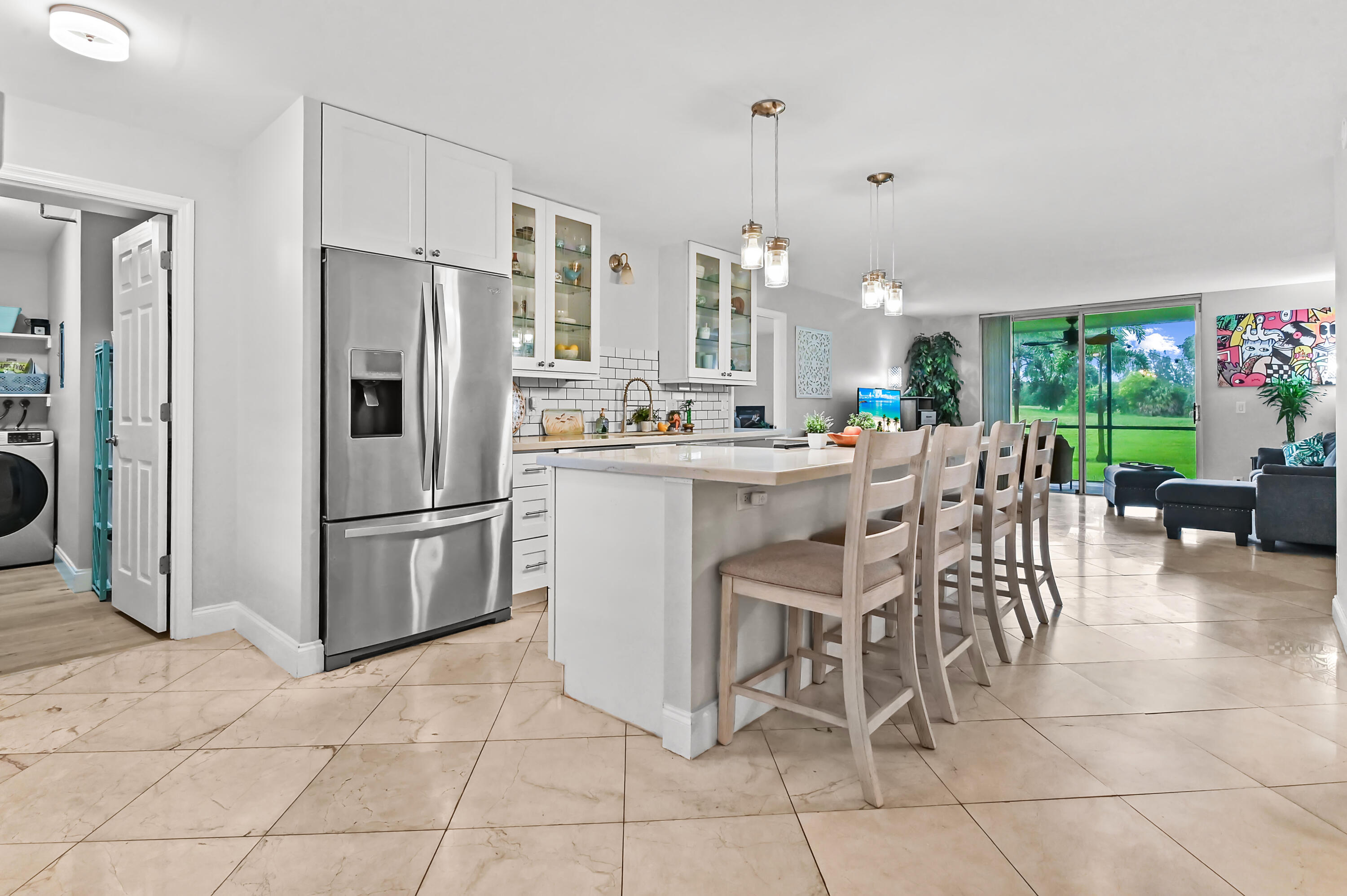 Beautifully remodeled 3-bedroom, 2-bath CORNER UNIT in sought-after Boca Teeca! This spacious ground-floor residence offers an open and airy layout filled with natural light and designed for comfortable living and entertaining. The updated kitchen features abundant cabinetry, generous counter space, and excellent storage, flowing seamlessly into the expansive living and dining areas. One of the home's standout features is the oversized screened patio, where you can enjoy peaceful garden views and direct access to lush green space, creating a unique indoor-outdoor lifestyle rarely found in condominium living. The split-bedroom floor plan provides privacy, while the large laundry room and plentiful storage add everyday convenience.  Located in a well-maintained East Boca community just minutes from beaches, shopping, dining, golf, and major highways. Enjoy easy access to the new 74-acre North Park Boca Raton, featuring walking and biking trails, themed playgrounds, a dog park, community gardens, and Florida's first indoor pickleball and padel complex. A rare opportunity to own a move-in-ready ground-floor corner unit with beautiful views, exceptional storage, and a prime Boca Raton location.