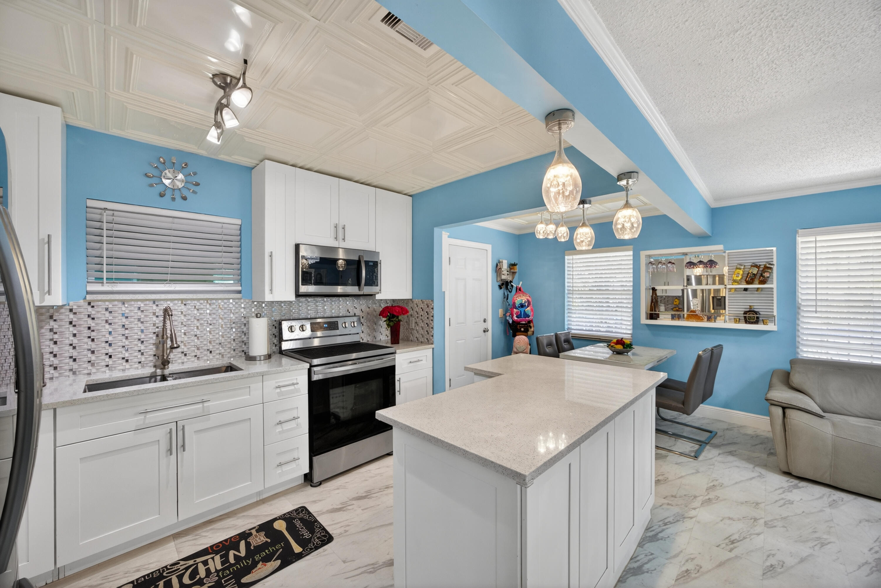 Beautiful, completely remodeled single-family home located in the heart of West Palm Beach! Just minutes from Rosemary Square, pristine beaches, I-95, major shopping centers, downtown, Palm Beach International Airport, and the exciting new Nora District. This move-in ready home features a modern open layout with tile flooring throughout, a fully upgraded kitchen with quartz countertops, sleek cabinetry, and stainless steel appliances. The bathrooms have been tastefully renovated with high-end finishes, offering both style and comfort.  Enjoy a spacious driveway and a large backyard with plenty of room to build your dream pool—perfect for entertaining and family gatherings. The home also boasts a covered rear porch with a fully equipped outdoor kitchen, ideal for hosting guests year-round.  Additional upgrades include a new A/C system and a newer roof for peace of mind. Washer and dryer are included. Don't miss this incredible opportunity to own a beautifully upgraded home in a prime location. Schedule your showing today—this one won't last!
