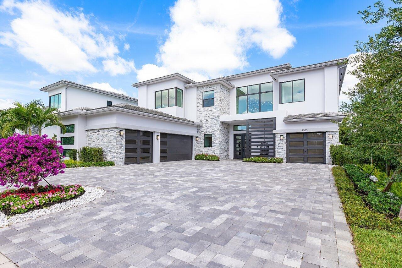 Welcome to a masterpiece of modern luxury in the exclusive Boca Bridges community. This custom-built Palermo Contemporary estate which is being sold Fully Furnished and Decorated transcends typical builder-grade homes, having been meticulously transformed by its visionary owners and designers.  Every inch of this residence reflects unparalleled craftsmanship, with extensive customizations, designer finishes, and thoughtful enhancements throughout.
This two-story estate boasts an array of lavish amenities, including 5 spacious bedrooms, 6½ elegantly appointed baths, a club room, and a state-of-the-art home theater with professional soundproofing—a six-figure investment in entertainment. The upstairs primary suite offers a private oasis with a morning kitchen and a wrap-around veranda. The home also features 2 laundry rooms and a 4-car air-conditioned garage.
Step inside to discover exquisite porcelain flooring, a wet bar, a summer kitchen, and a stunning pool area. The kitchen is a chef's dream, fully upgraded with top-of-the-line appliances, a gas range, an espresso station, refrigerator drawers, and even a pot filler. Luxurious details such as Venetian plaster walls, cove lighting, and a comprehensive camera security system elevate the living experience.
Additional features include a fully outfitted gym in one of the air-conditioned garage bays, multiple strategically placed ice makers, a child-proof locking system, a dog run, and several sub-woofer stations for an immersive sound experience. The property also offers electronic phantom screens, a water filtration system, fully outfitted closets, a turf yard, and a natural mosquito elimination system. The outdoor space is enhanced by 20-foot tall Brazilian Beauty Leaf and Bay Rum trees, imported for ultimate privacy.
The prestigious Boca Bridges community offers residents an unparalleled lifestyle, with a 27,000 sq. ft. clubhouse featuring an elegant lounge with a bar, a card room, a game room, and an indoor sports area. First-class amenities include fitness facilities, swimming pools, tennis and pickleball courts, and activities for all ages, rivaling the finest resorts.