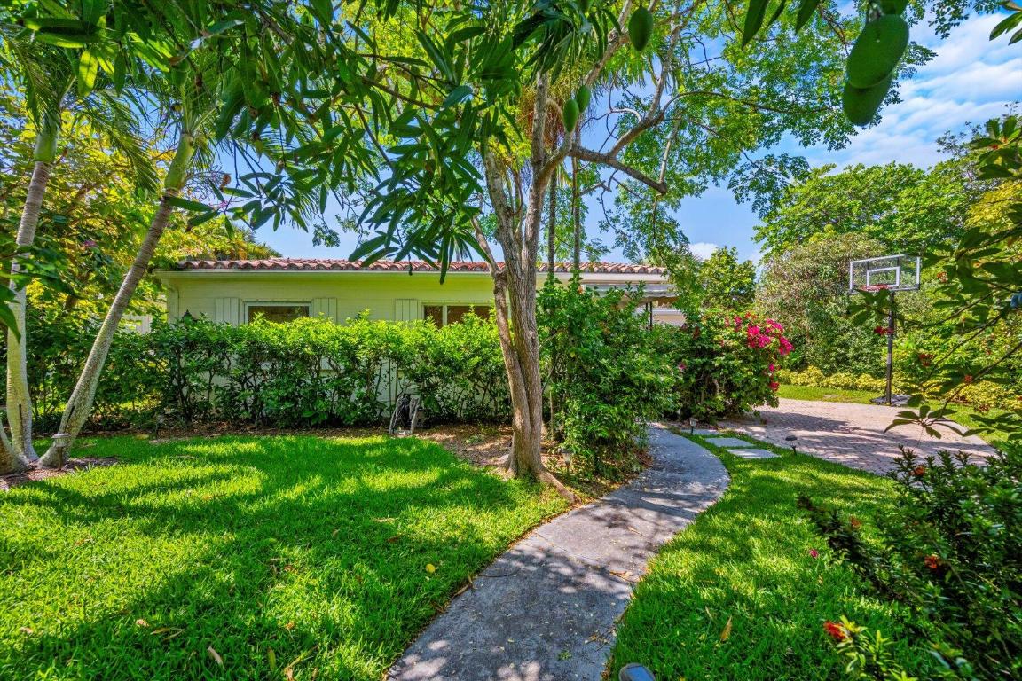 Beautifully maintained beach house on the North End featuring 5 bedrooms and 4 bathrooms, boasting a sunny great room with a fireplace, large pool/ patio area, and attached guest cottage with a vaulted ceiling. Situated on a corner lot with lush landscaping and plenty of parking, this delightful home is located near the beach, Lake Trail, and the inlet docks.