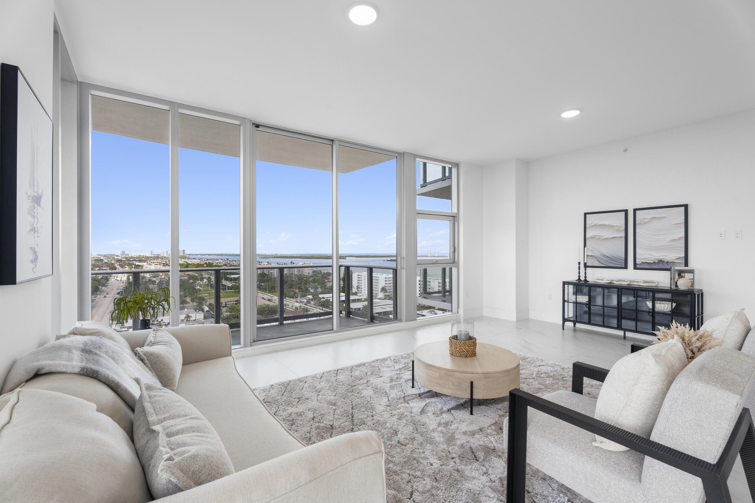 Now offered at $2,100,000- exceptional value for a rare 3-bedroom C residence with an expansive L-shaped floorplan with 10' ceilings and approx. 2,257 sq ft of interior living space and over 3,100 total sq ft including wraparound terraces per plans. This beautifully staged, never-lived-in residence offers a light-filled open kitchen and great room with sweeping west, north and east exposures capturing Intracoastal, ocean and marina views. Two spacious en-suite guest bedrooms plus a private primary suite with terrace access and stunning water views. One of the most desirable layouts in the building. Unlike other available units, this residence is professionally staged, allowing buyers to fully experience the scale, layout and lifestyle from the moment they enter. The open-concept kitchen flows seamlessly into the great room and out to an expansive wraparound terrace—creating true indoor-outdoor living rarely found in comparable residences. The thoughtfully designed split floorplan offers two generous guest suites, each with private baths, along with ample storage, a full laundry area and powder room. The primary suite is positioned on the south corner of the tower, featuring its own terrace and panoramic views of the Intracoastal, ocean and marina. Nautilus 220 delivers a full-service, resort-style lifestyle with a 6th floor amenity deck including a resort pool, spa, fire features, grilling stations, resident pavilion, putting green and dog park. Rooftop lap pool and spa. Additional amenities include club room, guest suites, conference rooms, fitness center, spin and yoga studios, sauna, steam room, massage room, bowling lounge, golf simulator, theater, music room, kids and teen rooms. Onsite waterfront dining by celebrity chef David Burke coming soon. 24/7 security, concierge, valet, EV charging, garage parking, and Singer Island beach access complete the offering.