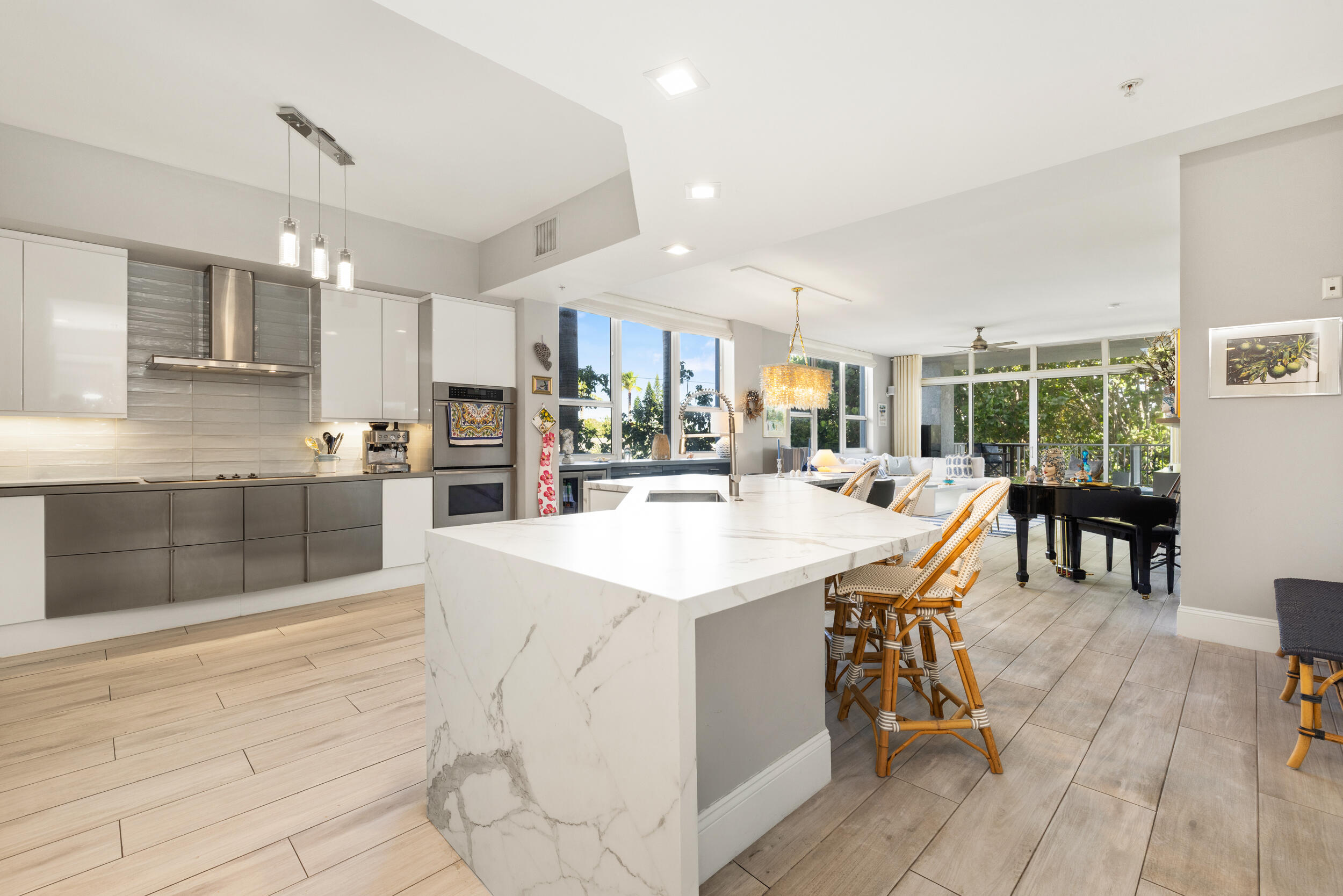 Enjoy refined coastal living in this bright 3BR/3BA corner residence in the heart of Deerfield Beach, just steps from the ocean and within walking distance to top restaurants, The Cove, and the iconic Deerfield Beach Pier. Surrounded by lush greenery, this private unit offers exceptional privacy and abundant natural light, with ocean views enjoyed from both the front terrace and rear balcony.  The open layout features high ceilings, motorized shades, custom closets, spa-like baths, and a chef's kitchen with premium appliances. Amenities include a heated pool, spa, fitness center with sauna and steam, underground parking, and private storage.