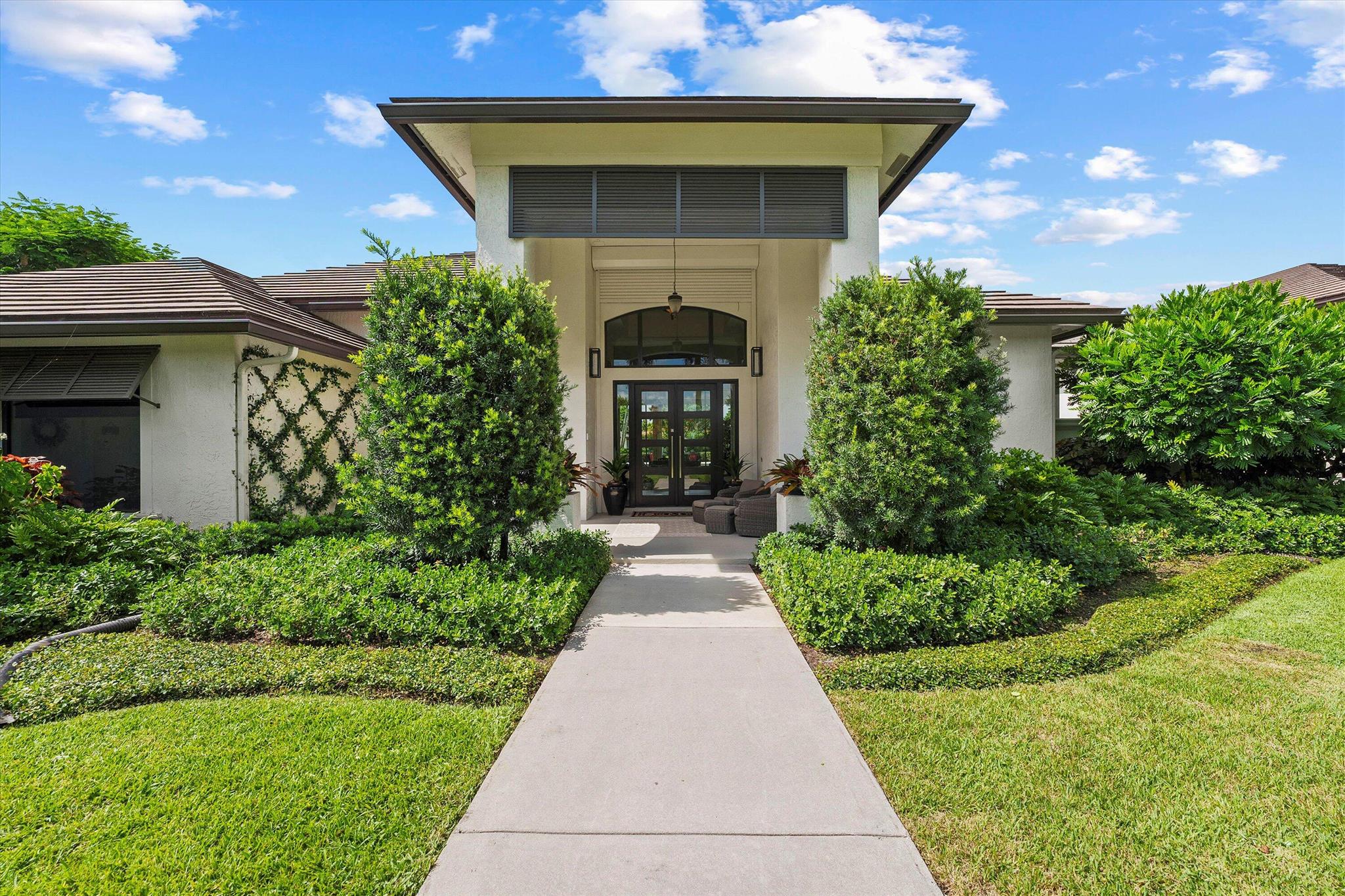 **Key Features:**
- 2.3-acre private, gated estate surrounded by mature trees
- 5,000+ sq. ft. home with 5 bedrooms, 4.5 baths, and an office with serene views
- Beautiful double-island kitchen with top-of-the-line finishes
- Recently updated -Heated saltwater pool, patio and landscaping
- New roof, impact windows and doors, full-house generator, 500-gallon propane tank, and new water filtration system.
- 5-stall barn with new 'Barn Walker' stall fronts and grates
-130x225 Wordley Martin riding ring and several grass paddocks
- Groom's apartment with separate entrance
- Standalone 2,000+ sq. ft. garage
- Direct access to bridle path, 25-minute hack to horse show
- Ideal for equestrian lifestyle and luxurious living
See Additional Comments Welcome to this exquisite 5,000+ square foot estate set on 2.3 acres of lush, mature landscaping, offering total privacy in a serene, gated setting. This luxurious home features 5 spacious bedrooms, 4.5 baths, and a dedicated office with tranquil views of the property. The heart of the home is the stunning double-island kitchen, perfect for both entertaining and everyday living.

Step outside to a beautifully refinished heated saltwater pool, surrounded by an updated patio and professionally landscaped grounds, offering a peaceful retreat. This home has been thoughtfully updated with modern amenities, including a brand-new roof, impact windows, a full-house generator, a 500-gallon propane tank, and a new water filtration system for added convenience and peace of mind.

For the equestrian enthusiast, this estate offers a state-of-the-art 5-stall barn with new 'Barn Walker' stall fronts and grates, a 130x225 'Wordley Martin' riding ring, and several lush grass paddocks set among beautiful mature trees. The property also includes a well-appointed groom's apartment with a separate entrance, ideal for live-in staff or guests.

Additional features include a standalone 2,000+ square foot garage and direct access to the bridle path, offering a scenic 25-minute hack to the horse show. This is a rare opportunity to own a private sanctuary with world-class equestrian facilities and exceptional living spaces.