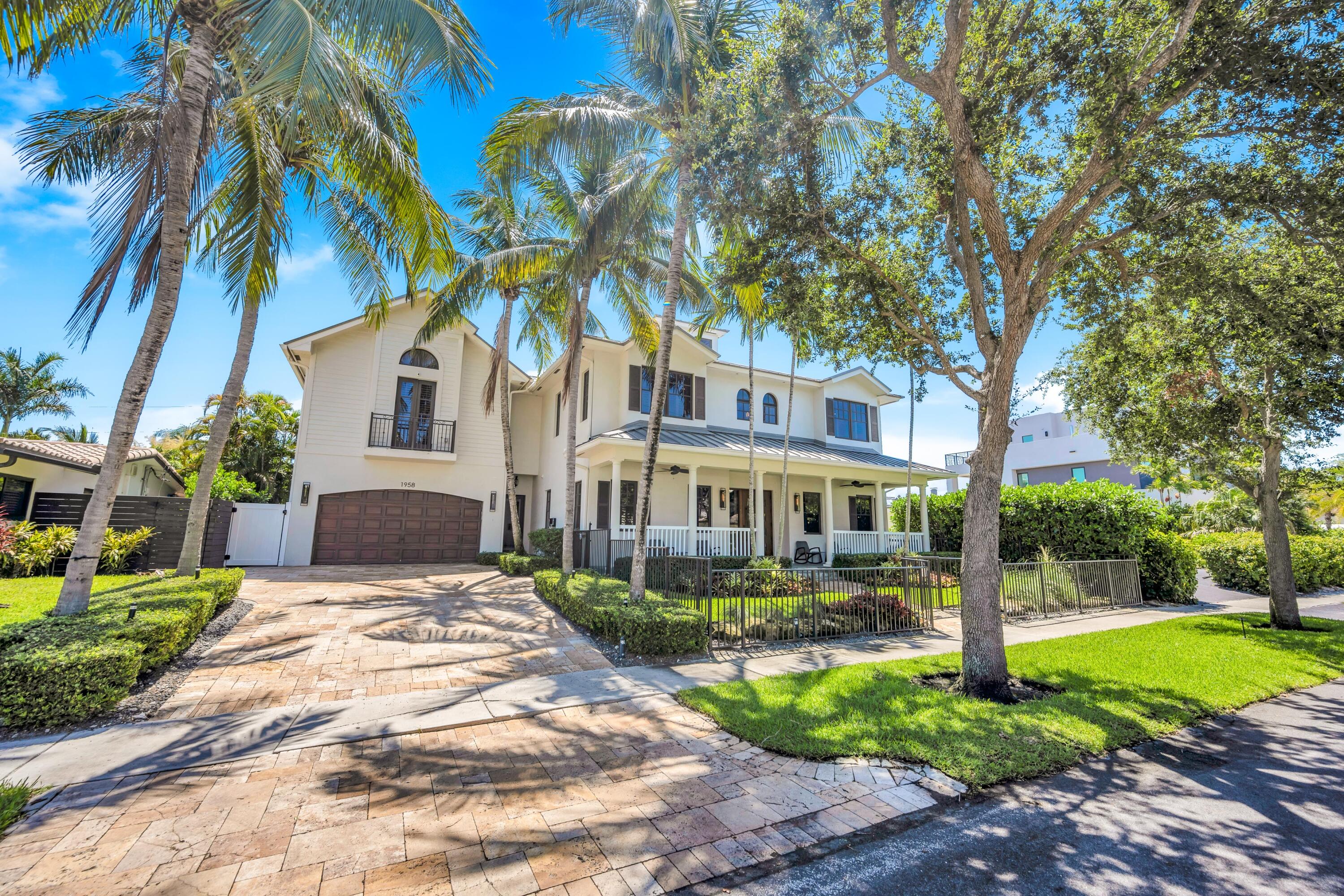 Tastefully updated in 2023, this move in ready, turnkey residence embodies the quintessential Florida Keys-style villa with thoughtfully curated designer finishes and recent fixture upgrades throughout. Breezy verandas, soaring ceilings, and effortless indoor-outdoor living create an inviting coastal retreat.  The ultra luxurious heated glass tile pool and spa are nestled within lush tropical gardens, offering pure escapism at its finest. Enjoy the serenity of one of the area's most sought-after neighborhoods, just moments from the beach.  The home features 4 spacious en suite bedrooms, plus a 5th en suite bedroom above the garage that functions perfectly as a guest suite, mother in law suite, game room, or private office.  Additional highlights include a formal dining room with seating for ten, a breakfast nook accommodating eight, a veranda with a custom swing bed, an outdoor lounge area with a fire pit, and a heated glass tile swimming pool with an integrated spa.  Recent capital improvements and upgrades include tasteful interior renovations, pool renovation, and interior paint completed in 2023; a new tankless water heater; new microwave; new upstairs washer and dryer; all toilets replaced throughout the home; custom-built pantry cabinetry; new pool pump housing and pool motor; two upstairs HVAC evaporator coils replaced in May 2026; two new HVAC systems installed in 2026, with three additional A/C systems installed in 2022; a whole-house natural gas generator; new front fencing; professionally upgraded tropical landscaping; and a metal roof installed in 2014.  A meticulously maintained residence offering exceptional mechanical updates, timeless design, and true turnkey luxury—ideal as a full-time residence, seasonal retreat, or high-end investment opportunity.