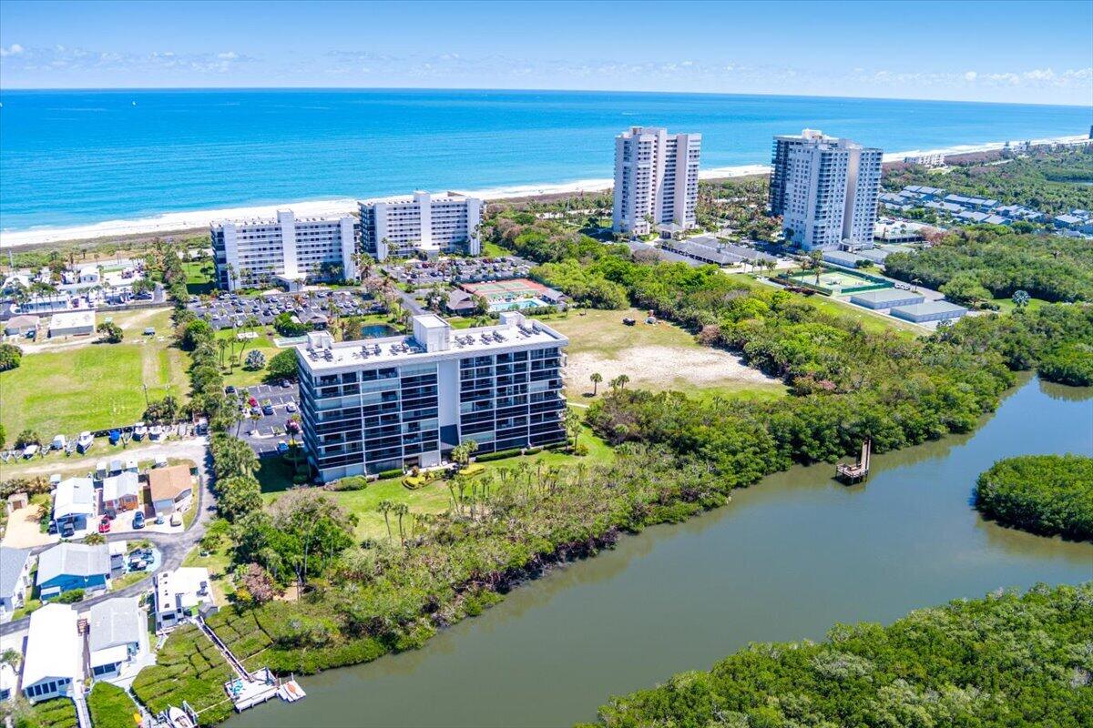 Experience refined coastal living in this exceptional 2-bed/2-bath corner residence, thoughtfully designed with a spacious split floor plan. Bathed in natural light, the expansive living areas feature coveted southern exposure and showcase breathtaking panoramic views—spanning from the turquoise Ocean to endless Intracoastal vistas, all complemented by vibrant coastal wildlife.The primary suite serves as a private sanctuary, offering stunning water views and a spa-inspired bath complete with a beautifully appointed double vanity, elegant tiled shower, and generous closet space.Located within a prestigious gated community, residents enjoy an array of resort-style amenities, including a heated pool, pickleball, and more. Ideally situated just minutes from the heart Vero Beach.