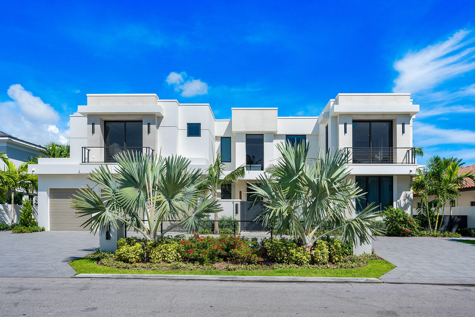 A masterpiece of modern waterfront living, this nearly new 2024 estate by SRD Building Corp., with interiors by award-winning P&H Interiors, commands a premier position on the coveted Buccaneer Palm Waterway. With 100 feet of yacht-ready frontage and a private dock, every element of this residence is curated for elegance and ease of life on the water.  Spanning more than 7,500 a/c square feet, the home reveals an atmosphere of refined grandeur the moment you enter its secure, gated courtyard. Beyond lies a world of resort-style luxury, where a sunlit pool and spa, expansive covered terrace, and a fully appointed outdoor bar create the ultimate setting for waterfront entertaining.  Inside, the state-of-the-art kitchen with eat-in dining flows seamlessly into the living spaces, while a club room, private study, and dedicated gym with sauna offer destinations for every pursuit. Two extraordinary master suites elevate the living experience, each with dual baths, custom closets, and private balconies that frame sweeping views of the waterway.  The residence balances grand scale with intimate comforts with five bedrooms, six full and two half baths, an elevator, and a 3-car plus golf cart garage. Smart-home technology with Crestron controls ensures modern convenience throughout. More than a home, it's a statement of lifestyle, craftsmanship, and waterfront prestige in Royal Palm Yacht & Country Club.
