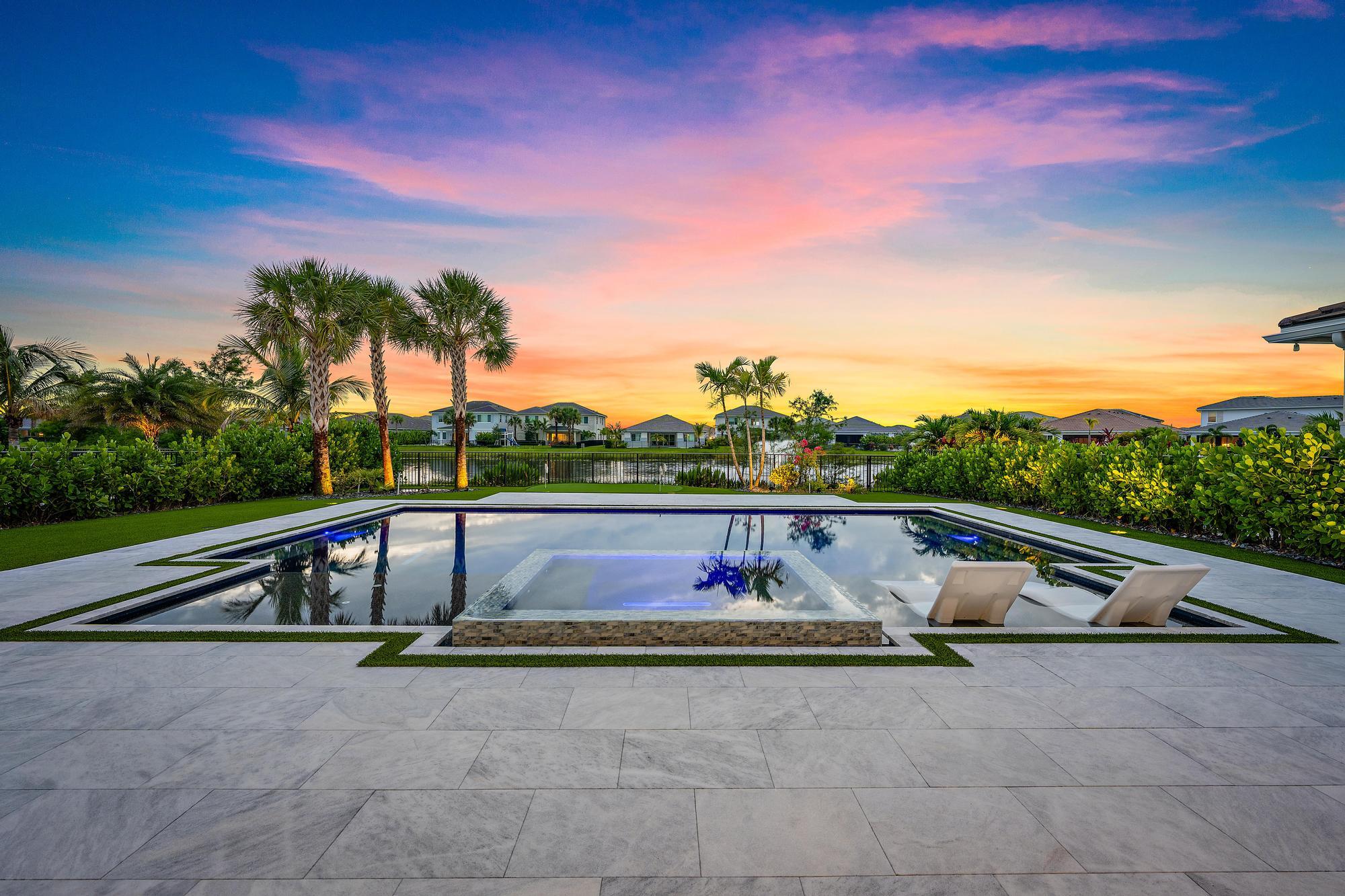 Built in 2023, this upgraded 5-bedroom, 4.5-bath home offers lake views, a private in-law suite, and a newly completed pool and spa. Features include hurricane-impact windows and doors, natural gas, a 3-car garage, and an open-concept floor plan. The kitchen is equipped with premium appliances and the living room features a custom wine display with a hidden door leading to a flexible bonus room ideal for a lounge, media room, gym, or office. The in-law suite includes a private entrance, living area, kitchenette, and laundry. Upstairs, a generous loft provides additional living space and separation between the primary and guest bedrooms. Outside, enjoy a fully fenced yard with synthetic turf, a putting green, and lakefront pool and spa, creating the perfect space for entertaining and outdoo outdoor living. Located in the gated community of La Terre at Avenir, this home offers access to the 16,000 sq ft Avenir Clubhouse, which features a fitness center, 8 tennis courts, 6 pickleball courts lap pool and a resort-style swimming pool, poolside cabanas spa, and splash pad.