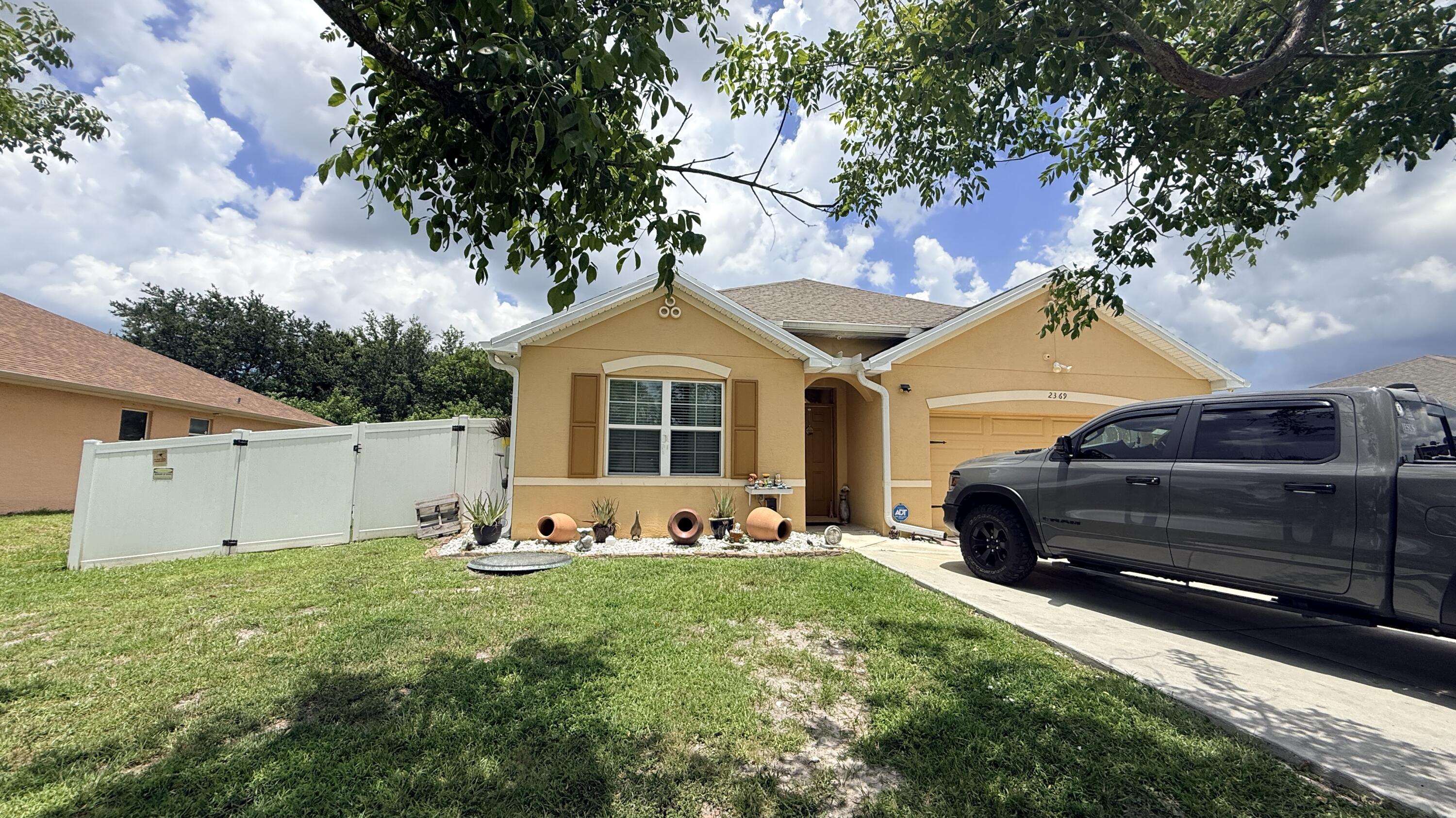 Welcome to this charming 4-bedroom, 2-bathroom home located in Port St. Lucie Section 18, offering 1,827 square feet of comfortable living space on a single story. The efficient floor plan provides excellent functionality for everyday living, with ample room throughout the residence. A 2-car garage provides convenient vehicle storage and protection from the elements. This well-proportioned home presents an opportunity to settle into the Port St. Lucie community and enjoy all that this established area has to offer. Buyer can assume the solar panels finance and save almost 60% on FPL bills. Two sheds in the yard, one oversized for your toys or a workshop. Extra concrete job in the amount of $15k around the property and a beautiful PVC fence also makes this home one of the kind.