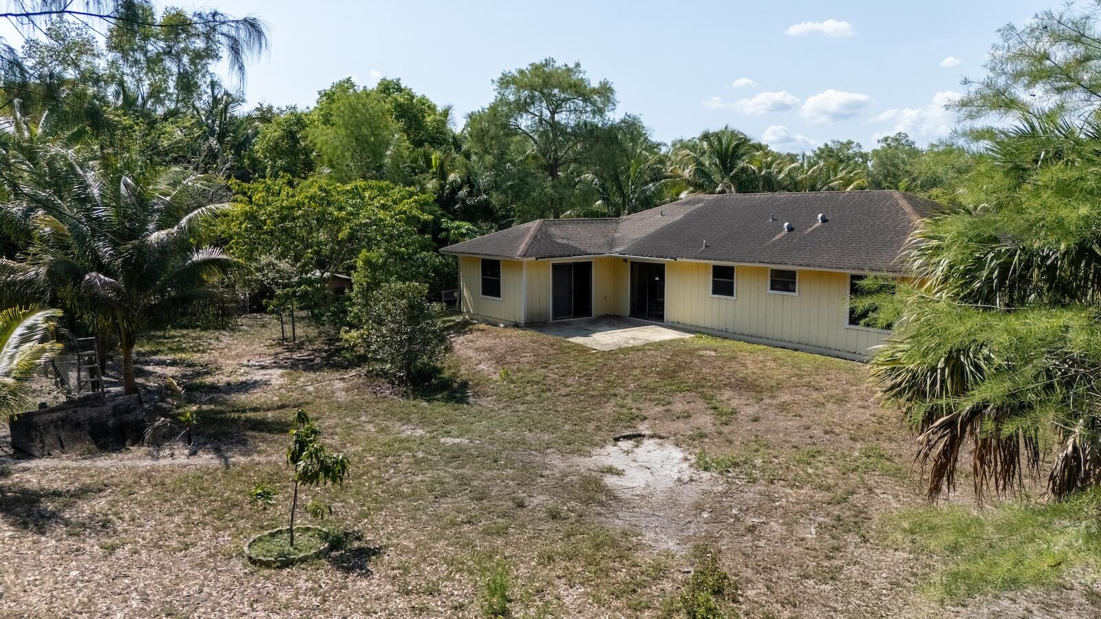 Spacious 3BR/2BA single-family home on a 1.47-acre lot in desirable Loxahatchee. The property needs some TLC but has incredible potential—perfect for investors, homeowners, or equestrian enthusiasts. Located in a horse-friendly community with no HOA. Property features a variety of mature fruit trees including mango, jackfruit, coconut, and more—an ideal setup for anyone who enjoys fresh, tropical fruit right in their backyard. Three adjacent lots are also available for sale. The city is actively upgrading the street with new asphalt paving in progress. Enjoy peaceful, rural living just minutes from new shopping centers, restaurants, and grocery stores. Cash or conventional financing preferred due to condition.