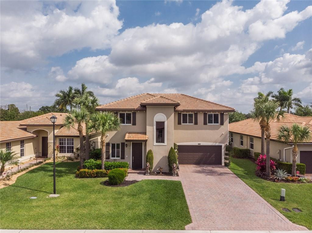BEAUTIFUL pool home in gated Vista Lago!  Not many come up in this pretty development! Built in 2016, seated near the end of a private street is this 4 bed, 2.5 bath two story home thats ready to go! Gorgeous contemporary saltwater heated pool with waterfall, deck jets, spa, and ample travertine pool deck. Located on HUGE fenced lot with room for parties, weddings, a garden, or even trampolines!! Parking for 4 in driveway and 2 in garage. All impact windows and doors, exterior cameras, outdoor seating with video/tv. Inside has 42" cabinets in kitchen, both living room and sitting room/parlor, all bedrooms upstairs with large primary walk-in closets. Schools are Christa McAuliffe Middle and Park Vista High! So happy to present this home to you! Assoc only 291!  covers LAWN, gate, cmmty pool, playground!