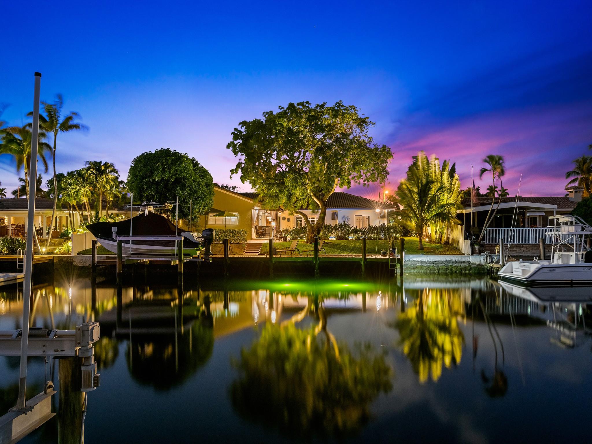 Discover waterfront luxury in this renovated 95' deep-water estate with ocean access. Boasting 4 bedrooms & 3 baths, the residence features a gourmet kitchen with gas range, Sub-Zero refrigerator, convection microwave, oven, warmer, pot filler, & a pull-out drawer pantry.Enjoy the Primary Suite with breathtaking pool & waterway views. The spa-like ensuite bathroom offers a jetted tub, oversized shower, & dual sinks. Seamlessly transition between interior & outdoor spaces to landscaped gardens, saltwater pool with fountain, & private dock with boat lift.Experience peace of mind with impact windows, doors, & whole house generator. Close proximity to private schools, fine dining, cultural attractions, & premier shopping. Elevate your lifestyle with this blend of luxury & convenience.