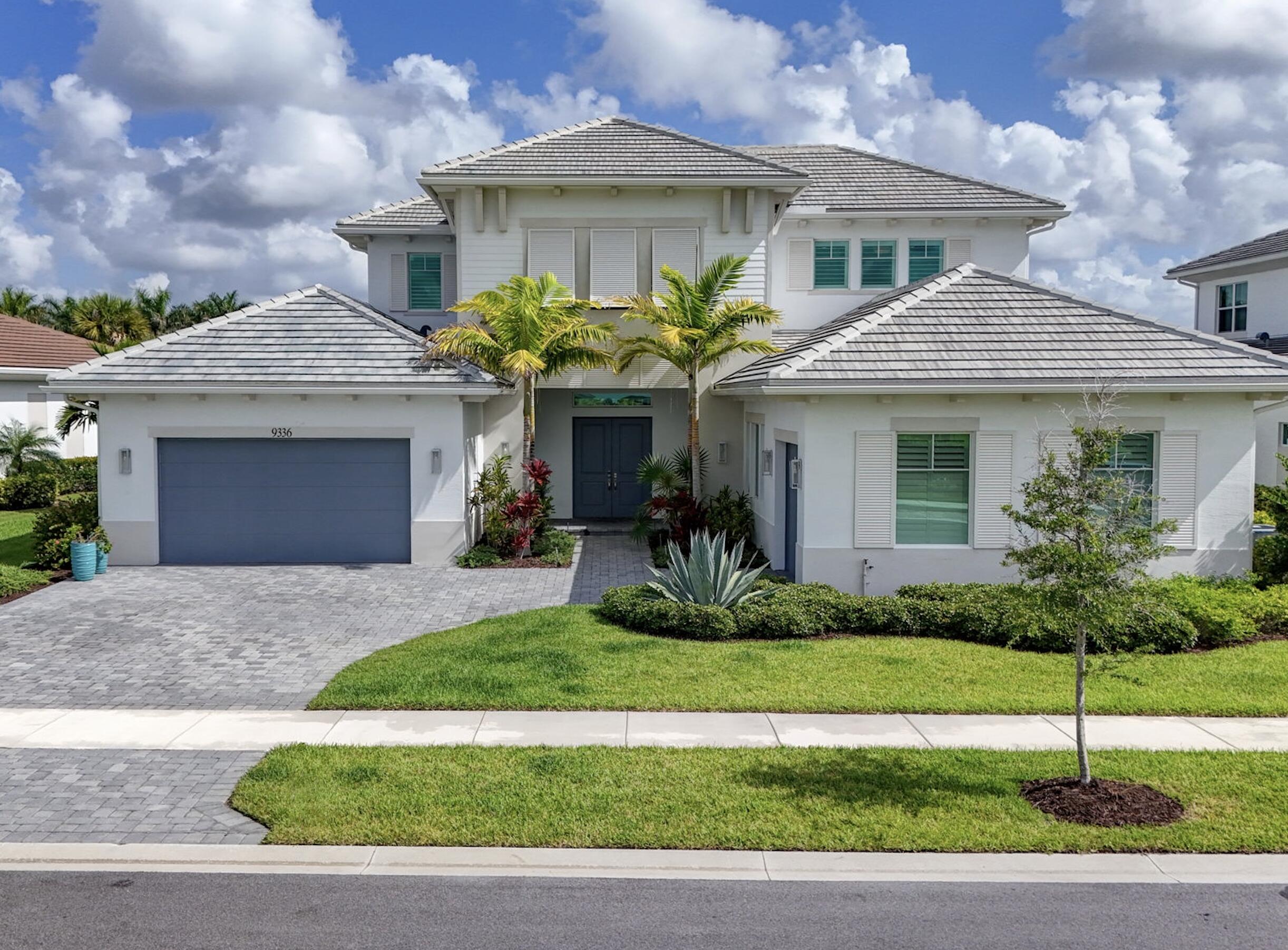 Situated on one of Avenir's most coveted estate homesites, 9336 Coral Isles offers 6,774 total square feet of thoughtfully designed luxury with exceptional craftsmanship, timeless finishes, and rare water views from both the front and rear of the residence. This remarkable five-bedroom, six-full-bath, one-half-bath estate is perfectly positioned to capture spectacular sunsets each evening while offering a sophisticated lifestyle in one of Palm Beach Gardens' most desirable communities. Designed for both everyday living and effortless entertaining, the expansive downstairs family room serves as the heart of the home and easily functions as a home office or media space. The covered lanai overlooks the resort-style pool and exceptional waterfront setting, while a convenient cabana bath enhances the outdoor living experience. Two separate laundry rooms—one upstairs and one downstairs with two washers and two dryers—provide outstanding functionality for family and guests. Every detail has been thoughtfully considered, including premium Sub-Zero and Wolf appliances, a full-house generator, an integrated security system, and an extraordinary level of upgrades throughout. Move-in ready and beautifully maintained, this is a rare opportunity to own one of Avenir's most distinguished waterfront estates, where luxury, lifestyle, and breathtaking views come together in perfect harmony.