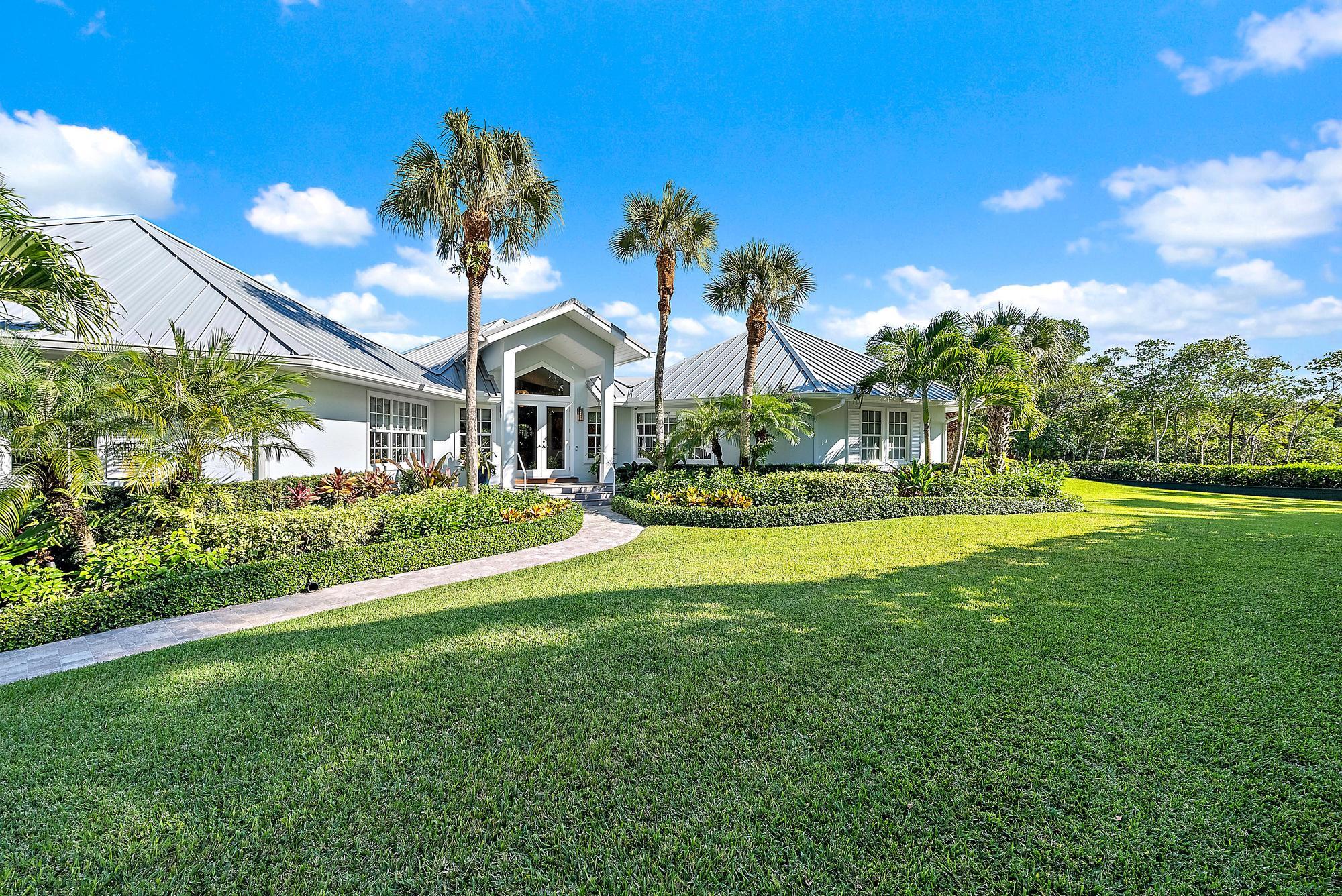 105 Harbor Way is a wonderful waterfront set on 1.5 acres of lush, tropical landscaping. This private retreat offers a dock with lift, plus full water and electric. Enjoy deeded beach access and the tranquility of being tucked away at the end of a secluded private lane on a canal a minute away from the Intracoastal. The house features a new metal roof, impact windows and doors, an expansive deck, and a beautifully renovated pool and spa. All just short ride away from town and nearby airports — the perfect blend of convenience, luxury, and privacy.