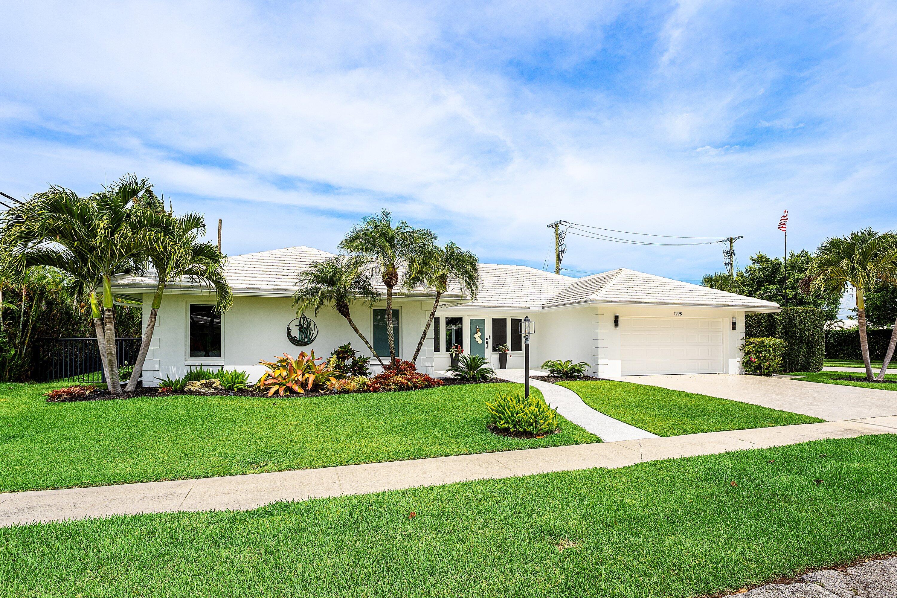 Completely reconstructed from the concrete shell under permit in 2018 and issued a new Certificate of Occupancy, this exceptional 4-bedroom, 3-bath residence combines the quality and efficiency of a much newer home with the charm of one of East Boca Raton's most sought-after neighborhoods. A NEW ROOF (2025) with a limited lifetime transferable tile warranty adds even greater long-term value and peace of mind. Ideally situated on a beautifully landscaped quarter-acre corner lot in Camino Gardens, the bright open floor plan features 9-foot ceilings, crown molding, wide-plank porcelain tile flooring, recessed lighting, built-in speakers, and oversized impact sliding glass doors that open seamlessly to a private tropical backyard. Designed for both everyday living and entertaining, the kitchen showcases marble countertops, a glass tile backsplash, soft-close cabinetry, black stainless KitchenAid appliances, a built-in wine refrigerator, and a large center island overlooking the custom built-in entertainment wall with bar and spacious living areas. A rare feature in Camino Gardens, the split-bedroom layout offers two private en suite bedrooms with walk-in closets and direct access to the pool and patio, providing exceptional flexibility for guests, extended family, or multigenerational living. The fully fenced east-facing backyard is a private retreat featuring an expanded and resurfaced patio surrounding a heated saltwater pool completely rebuilt in 2020 with a decorative water feature, new pump, and lifetime pool finish warranty. Additional upgrades include impact windows and doors, two-zone A/C, a one-year-old tankless water heater, 50-amp generator inlet, stamped concrete driveway, two-car garage, fresh interior and exterior paint, interior laundry room, low HOA, and an unbeatable location within the Addison Mizner school district just minutes from the beach, Mizner Park, downtown Boca Raton, I-95, Trader Joe's, The Fresh Market, and Publix.
